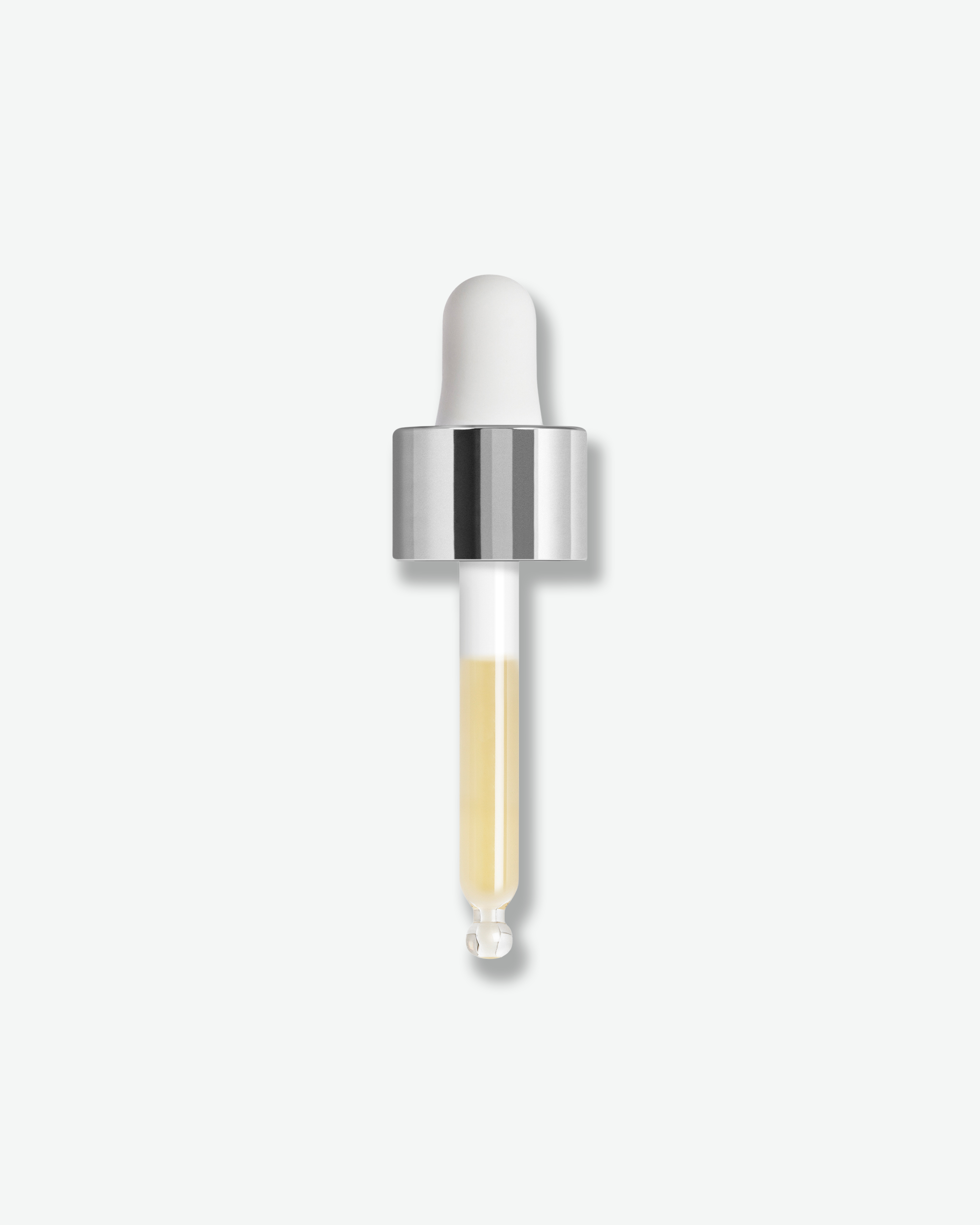 A glass dropper bottle containing a pale yellow liquid, featuring a white rubber bulb and a shiny silver collar, centered on a light gray background.