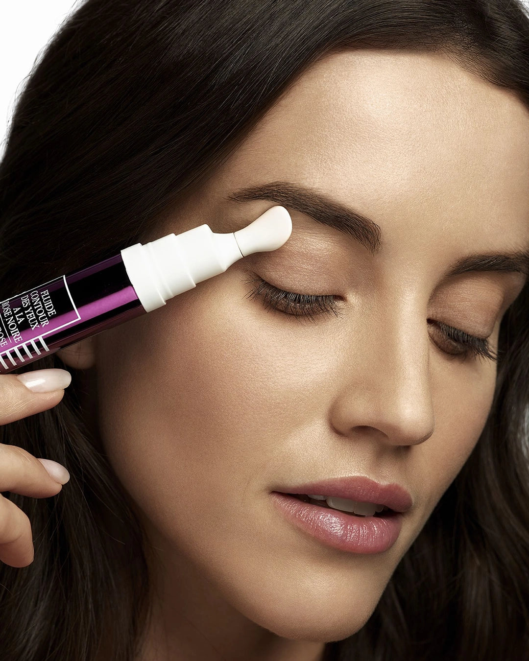 Woman applying Black Rose Eye Contour to her eye