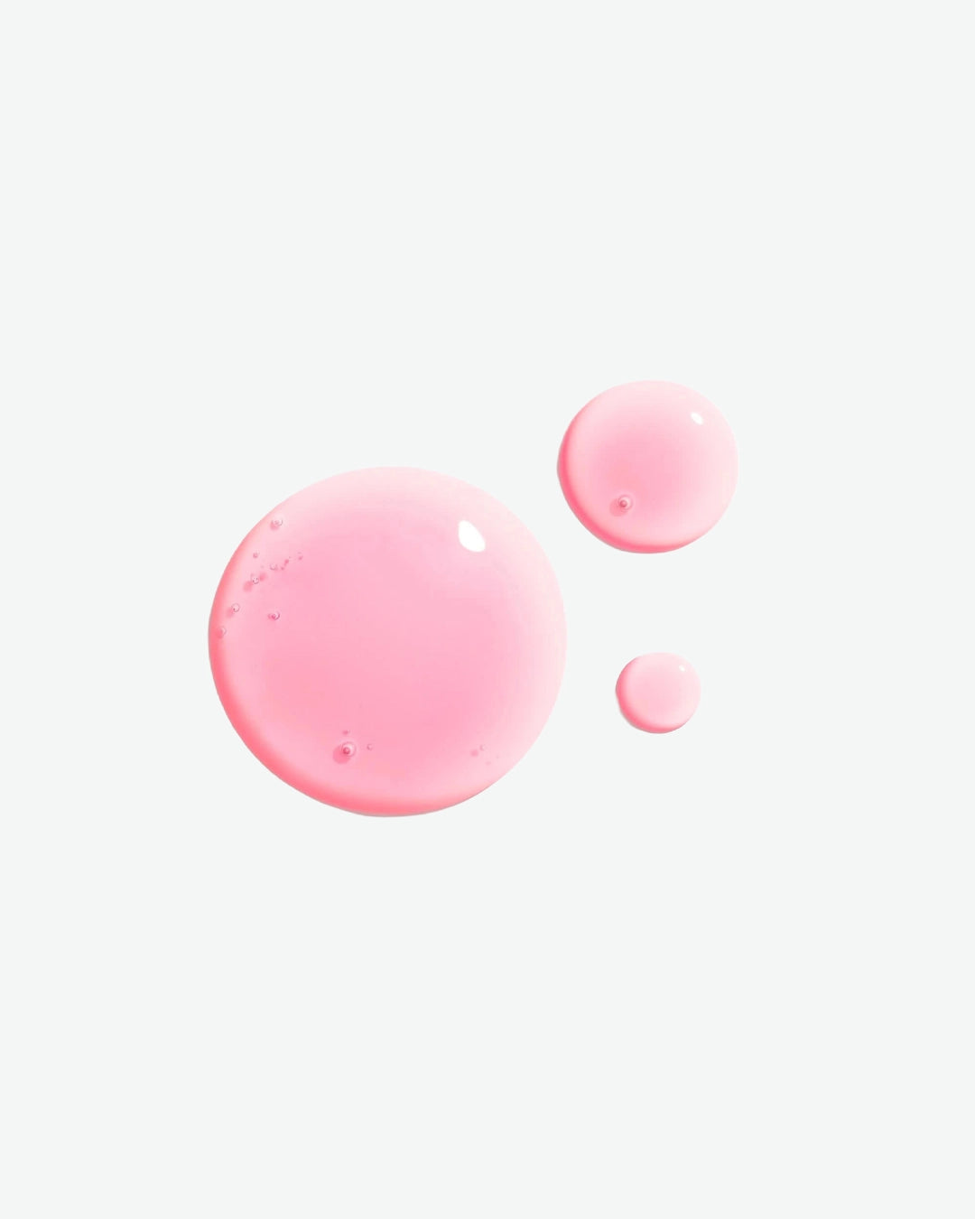 Pink liquid droplets on a white background