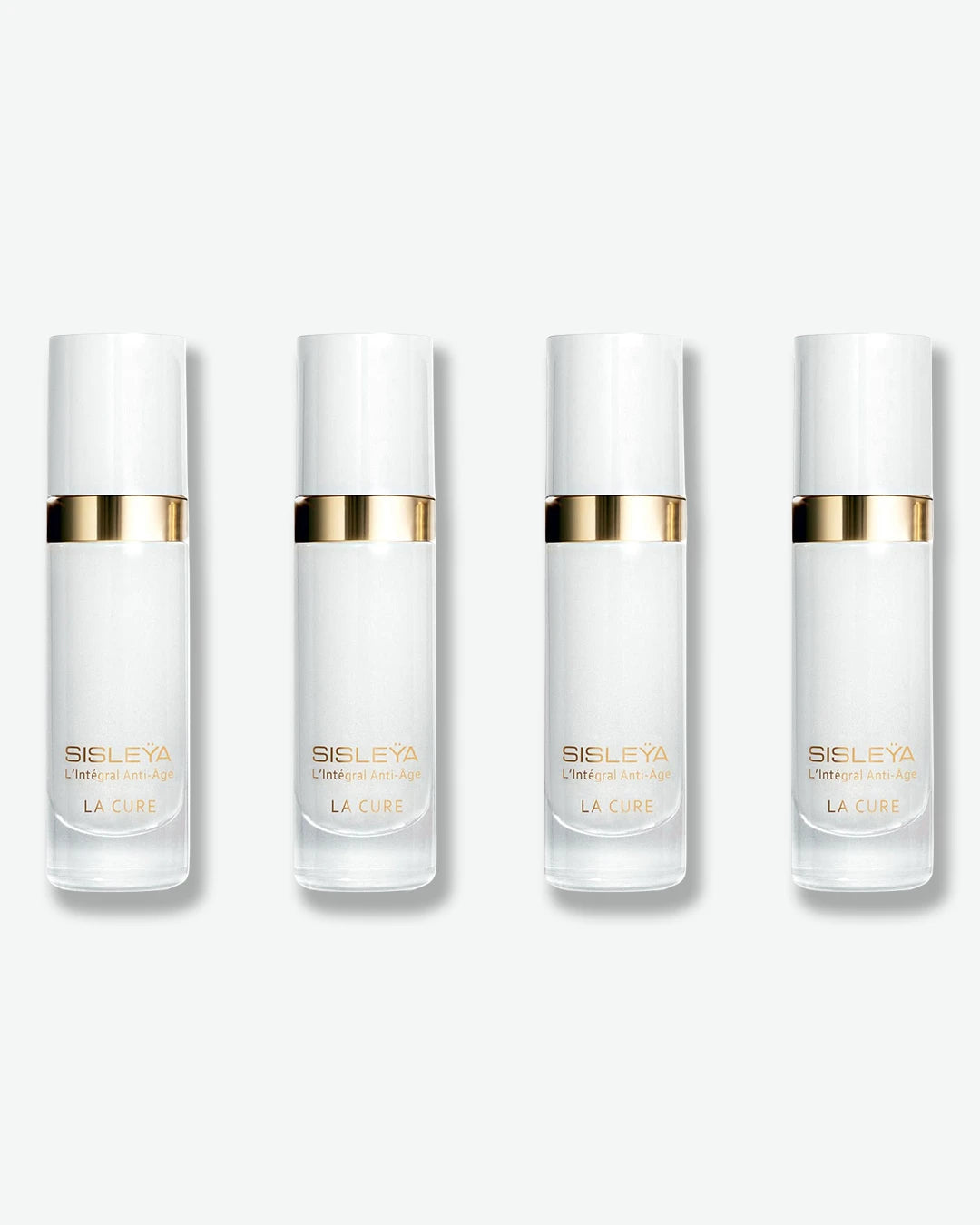 A row of four identical Sisley Paris Sisleÿa L'Intégral Anti-Âge La Cure serum bottles, featuring frosted white bodies and metallic gold neck collars.