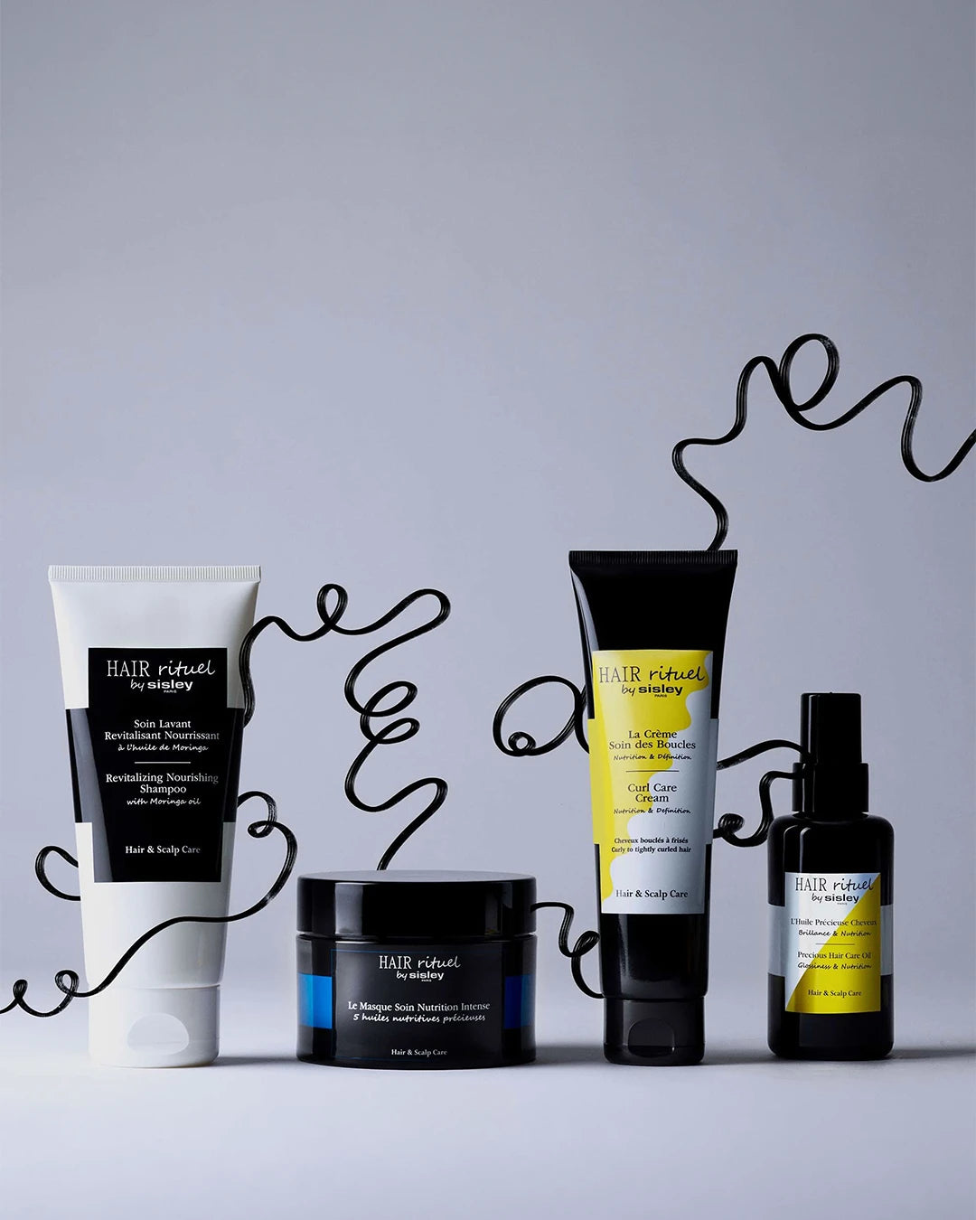 Collection of Hair & Body Works hair care products on a gray background