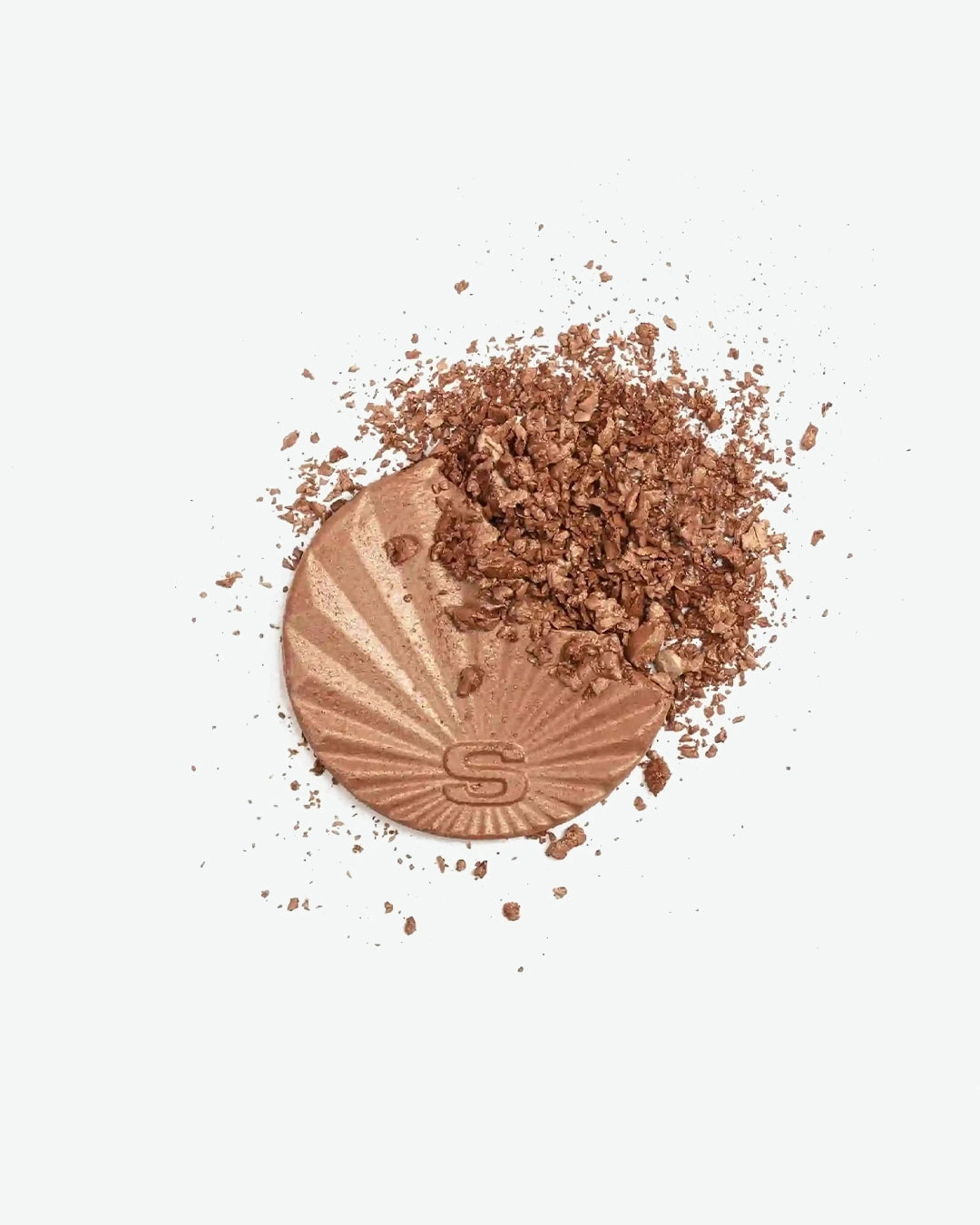 Bronze makeup texture image with scattered powder on a white background