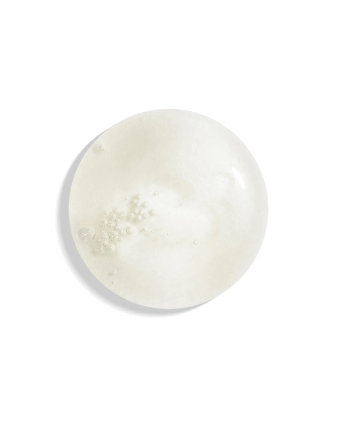 Round white cream with textured surface on a white background