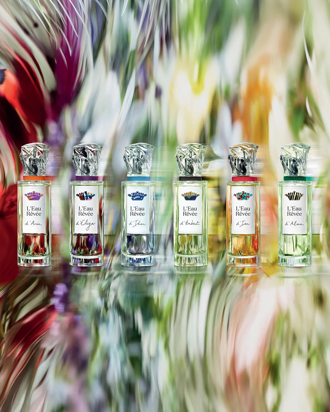 Set of six perfume bottles with colorful blurred background