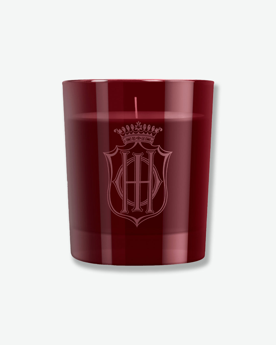 Red candle with a logo on a light gray background