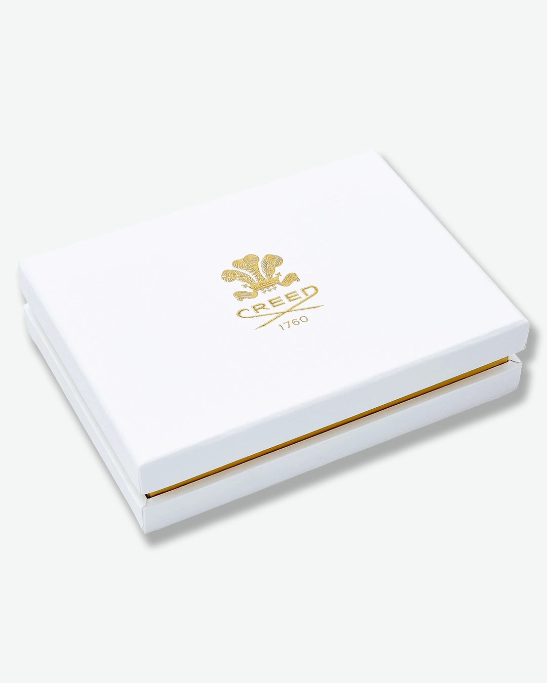 White box with gold accents and Creed logo on a white background
