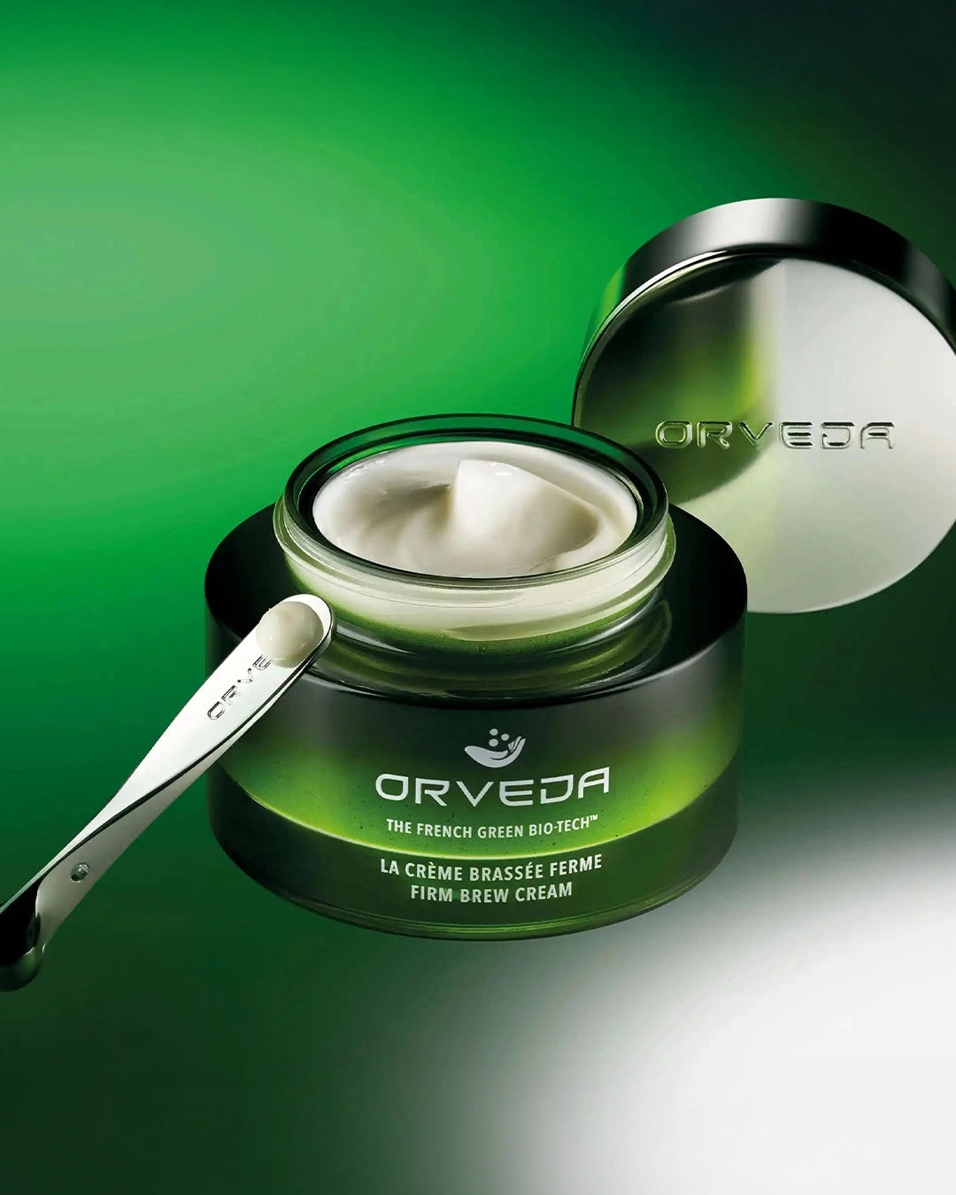 Orveda cream jar with a spoon on a green background