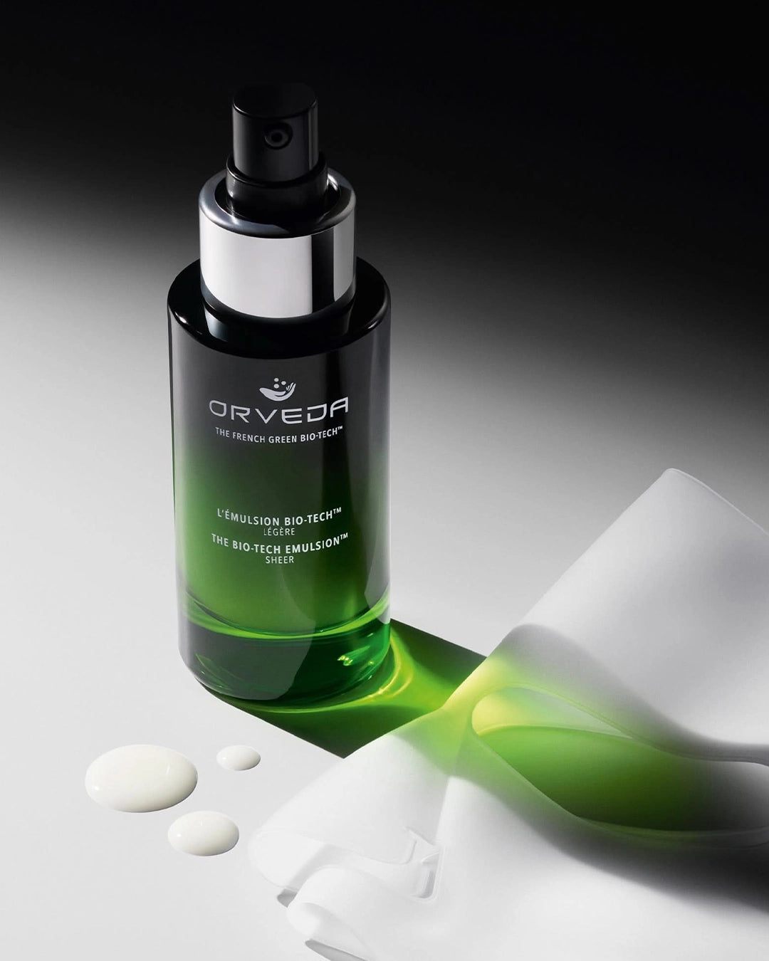 Orveda skincare bottle with green liquid on a dark background
