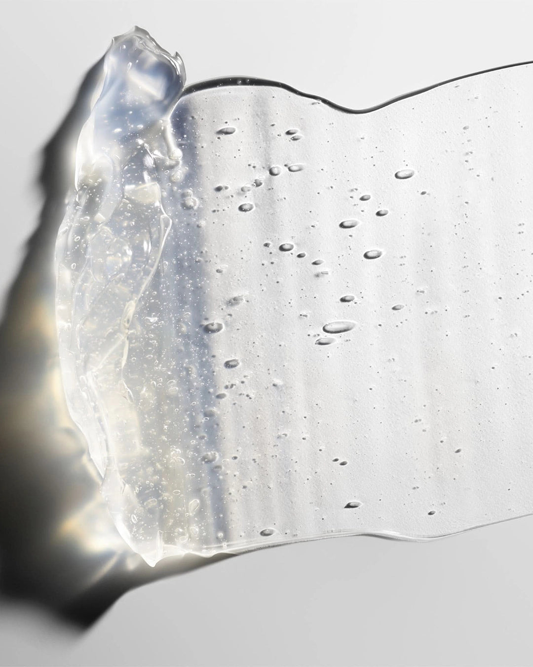Close-up of a clear gel-like substance on a light gray background