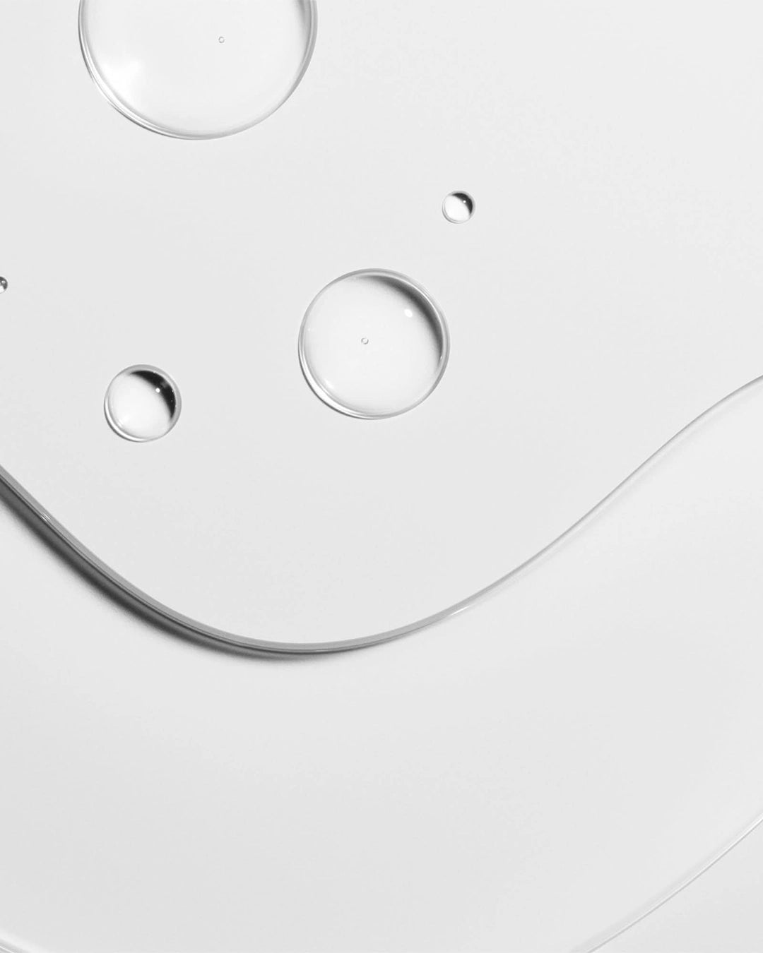 Close-up of a clear serum on a white background