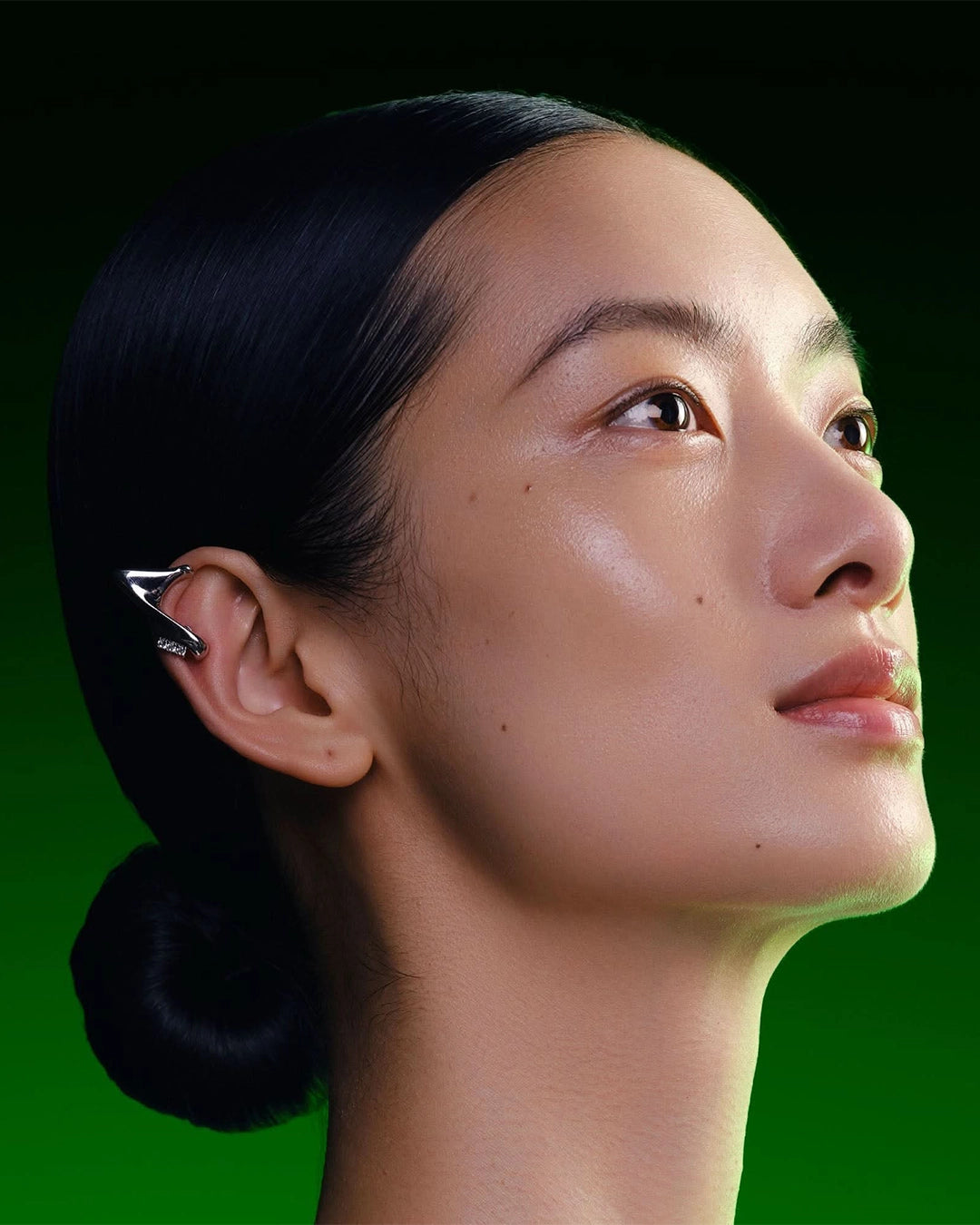 Close-up of a person with a hair clip on a green background