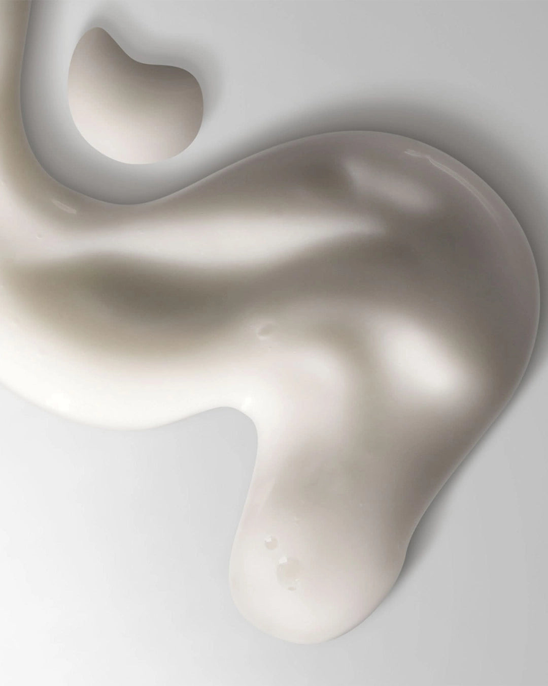 Abstract white cream on a light gray background