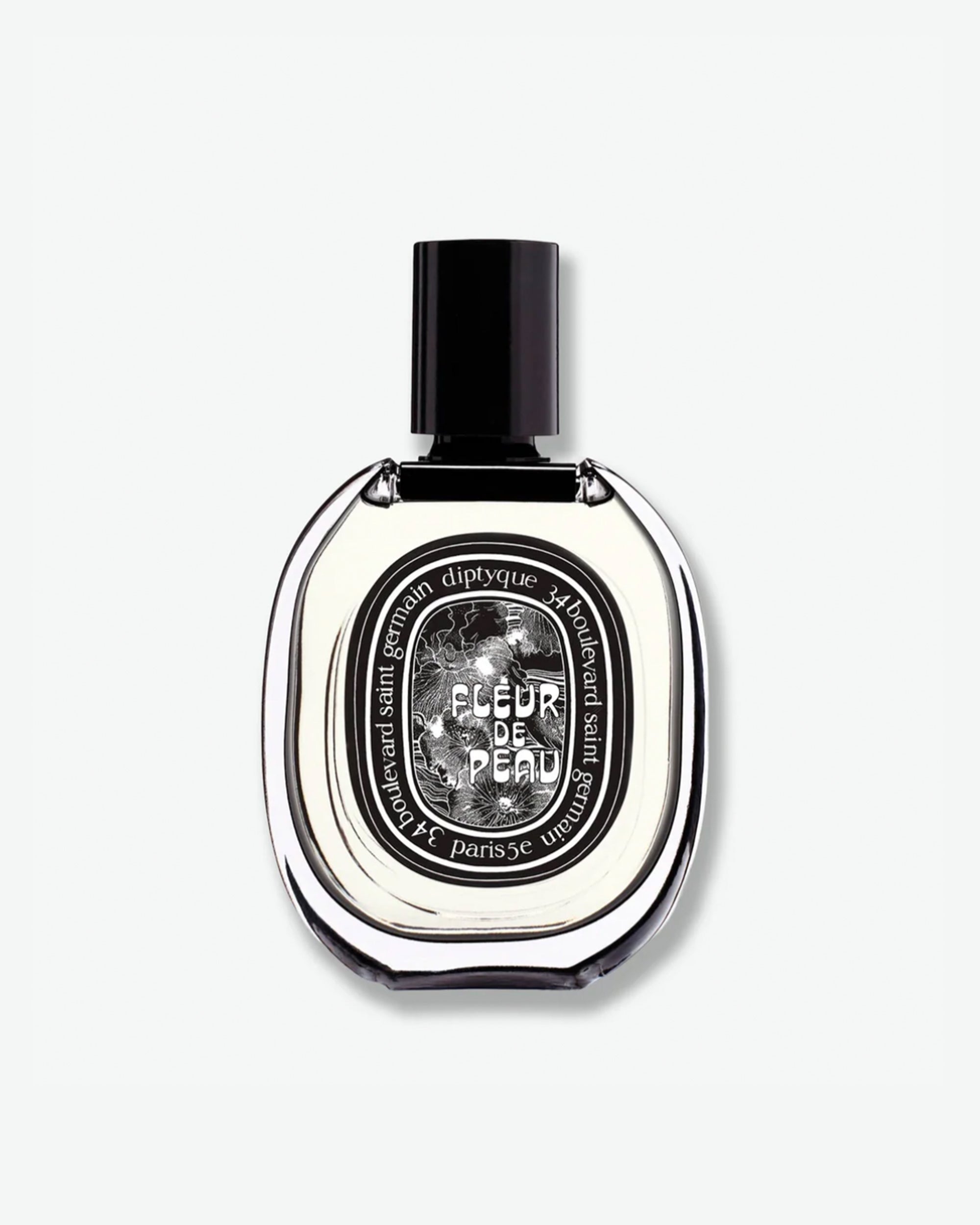 Diptyque Fleur de Peau Eau de Parfum in a signature oval clear glass bottle with a black cap and an intricate black and white illustrated label, isolated on a light grey background.