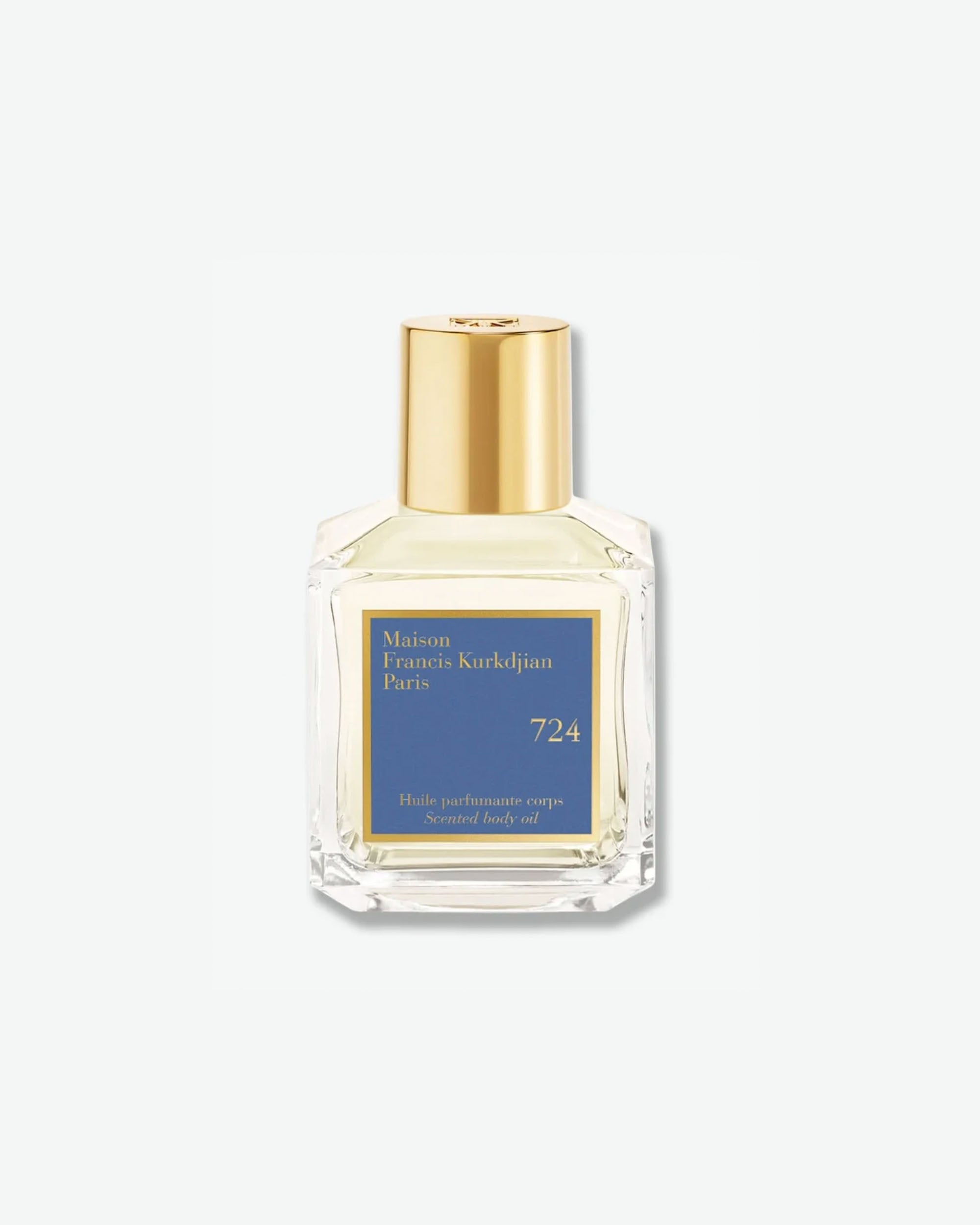 Front view of a square clear glass bottle with a gold cap containing Maison Francis Kurkdjian Paris "724" Scented body oil (Huile parfumante corps), featuring a blue and gold label.