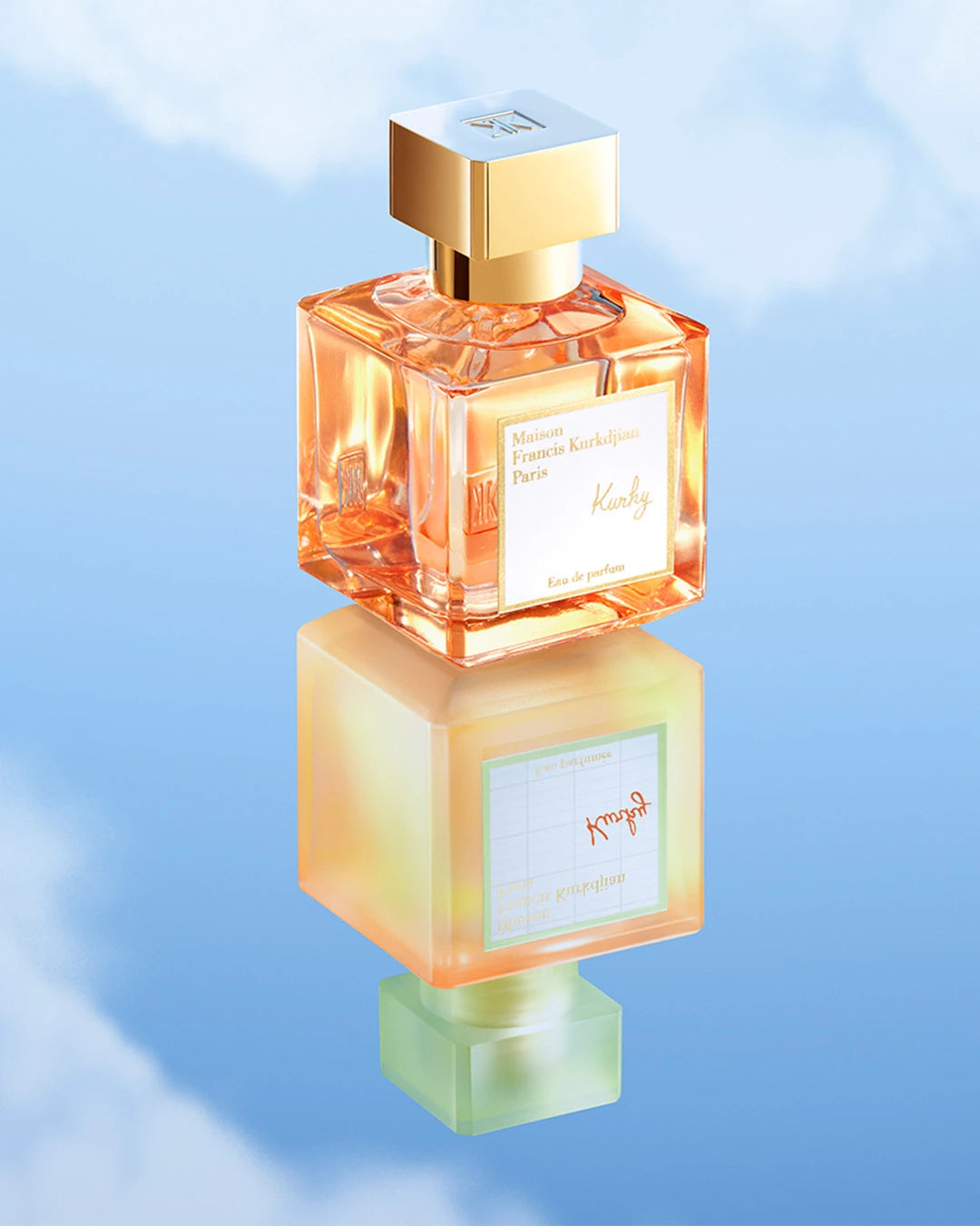 Perfume bottle with gold cap on a reflective surface against a blue gradient background