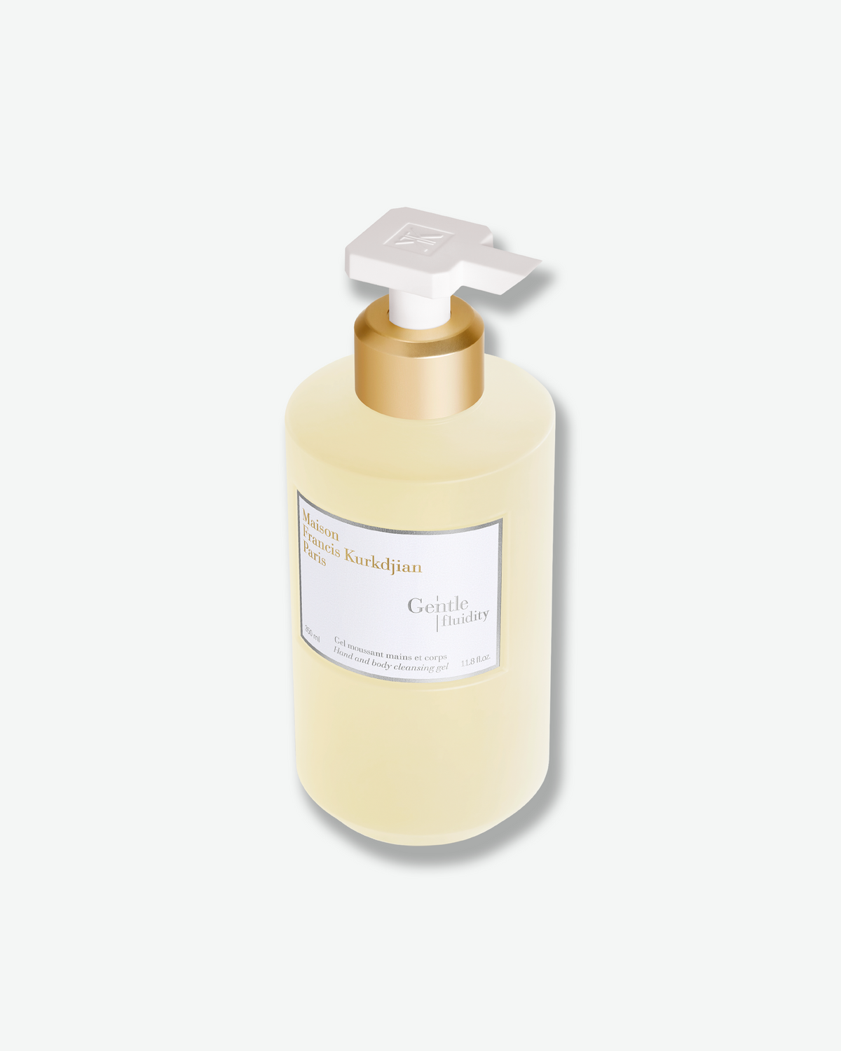 Angled view of the Maison Francis Kurkdjian Gentle Fluidity Hand & Body Cleansing Gel, featuring its white pump and polished gold collar.