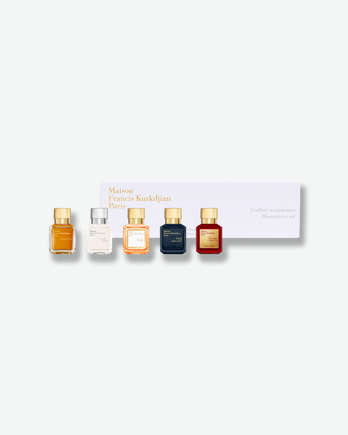 Maison Francis Kurkdjian Miniatures Set featuring five miniature fragrance bottles arranged in front of a white gift box with gold lettering.