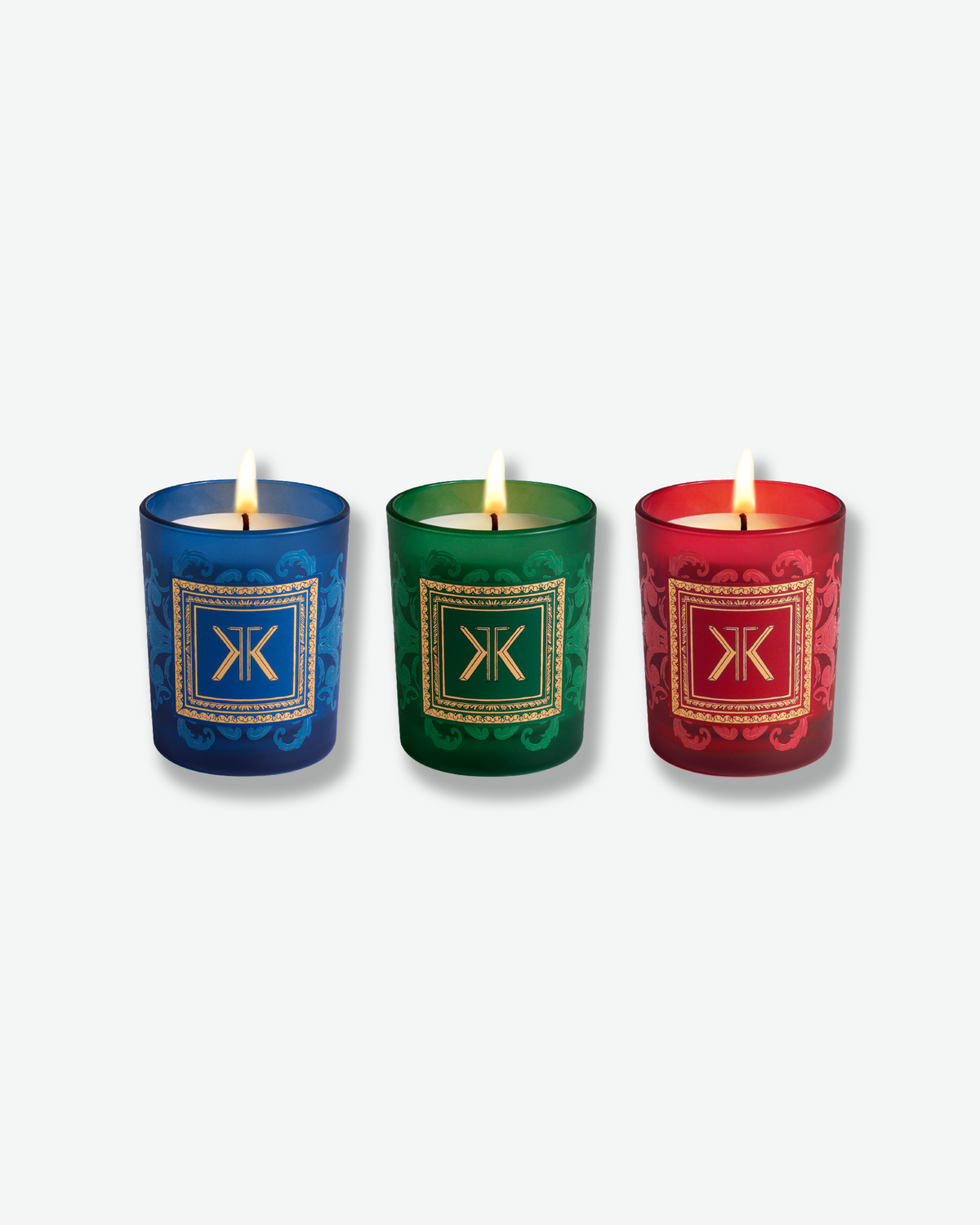 Maison Francis Kurkdjian 1, 2, 3 Noël candle gift set featuring three festive candles in blue, green, and red glass with ornate gold detailing and holiday gift box.