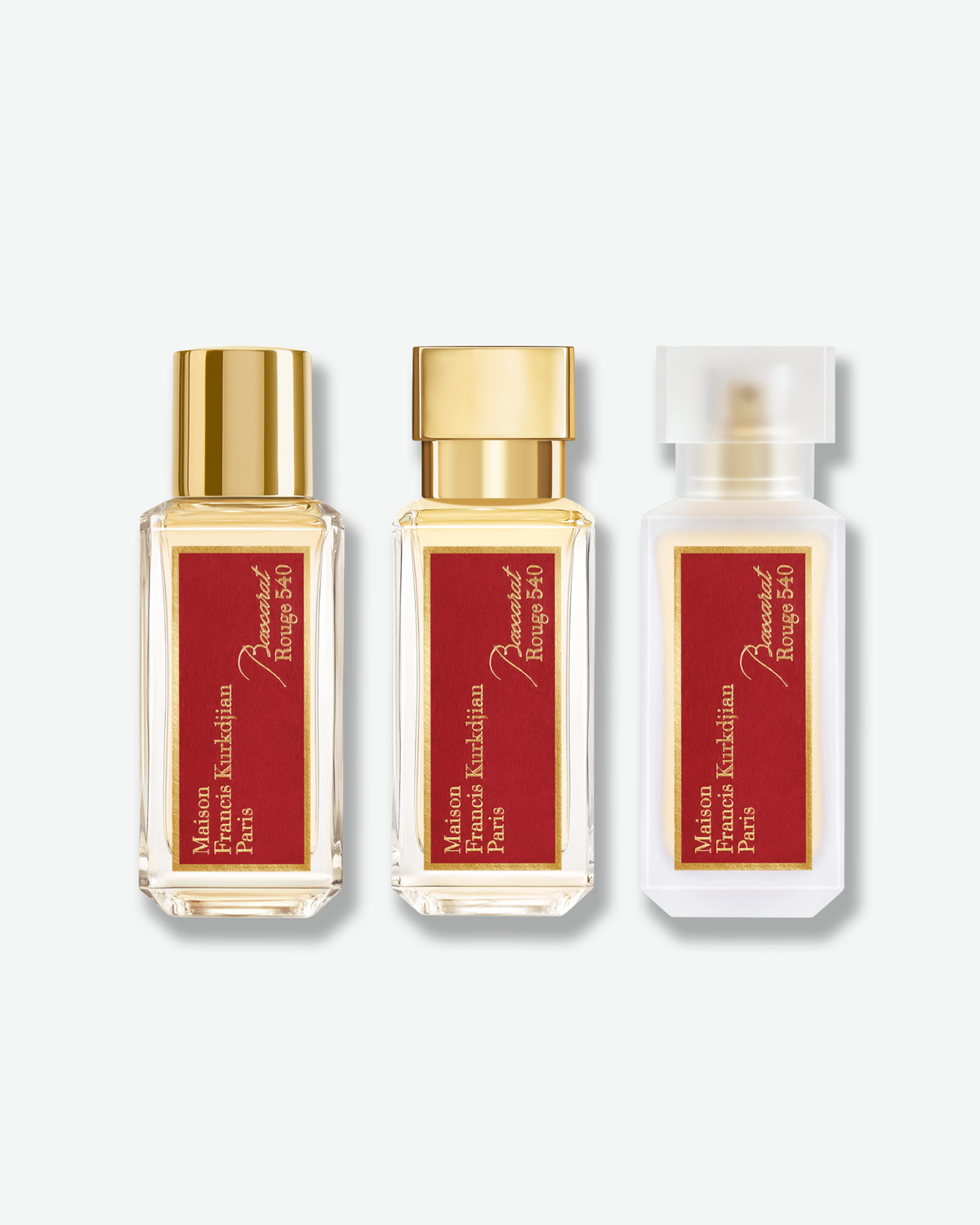 Maison Francis Kurkdjian Baccarat Rouge 540 fragrance ritual set featuring three bottles with red and gold labels: eau de parfum, scented body oil, and hair perfume.