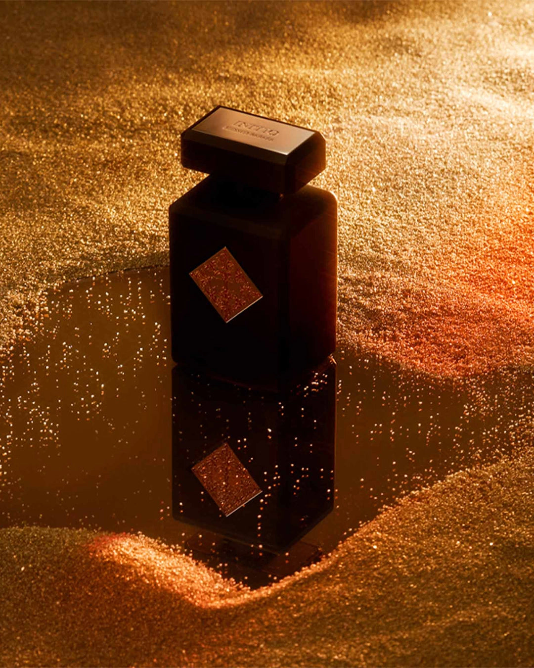 Dark brown bottle with geometric design on a textured gold surface