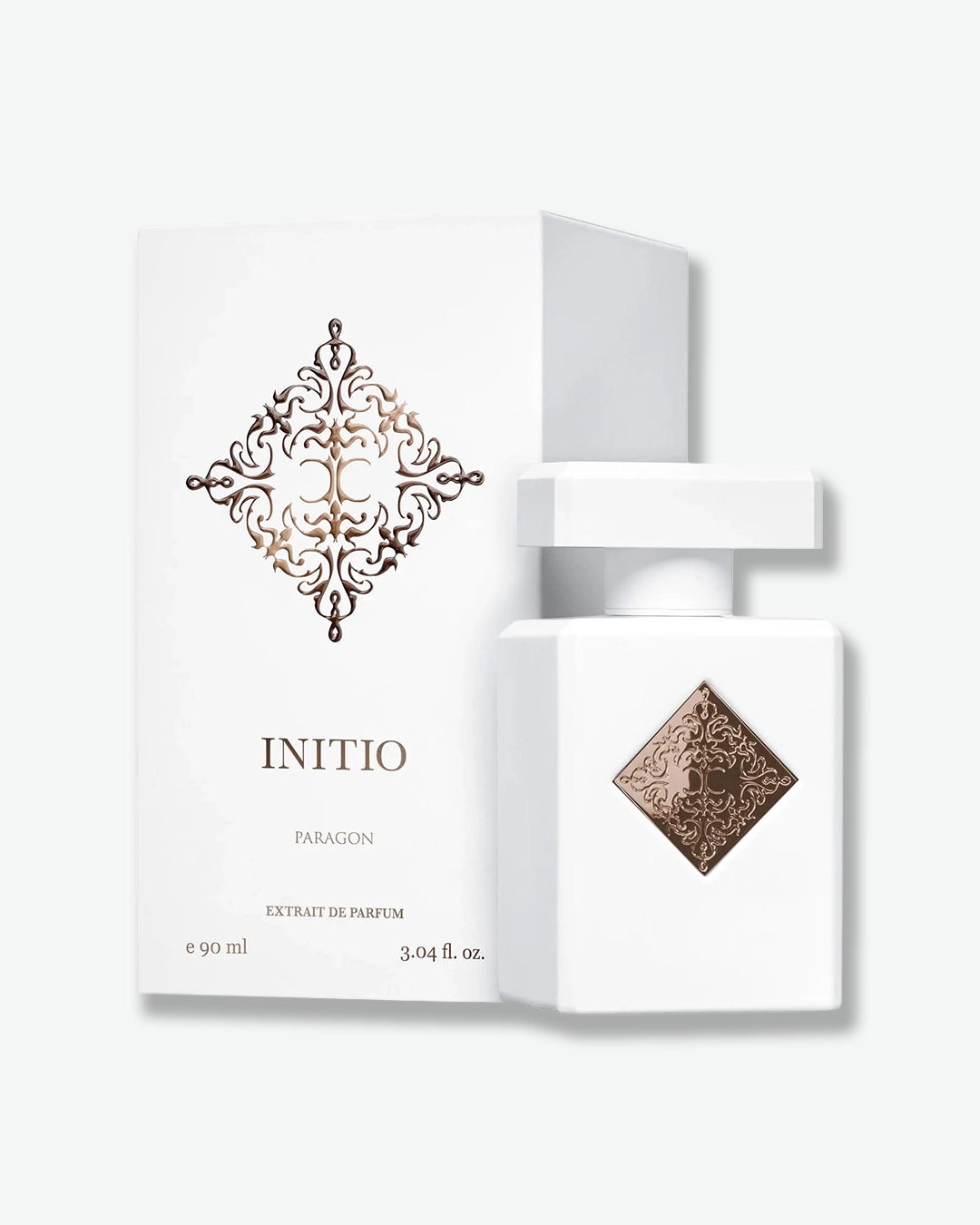 White perfume bottle with decorative design and 'INITIO' branding on a white background