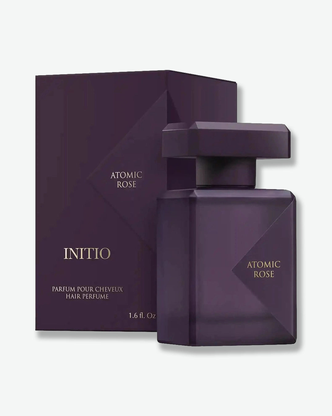 Purple hair perfume bottle and packaging with 'Atomic Rose' branding on a white background