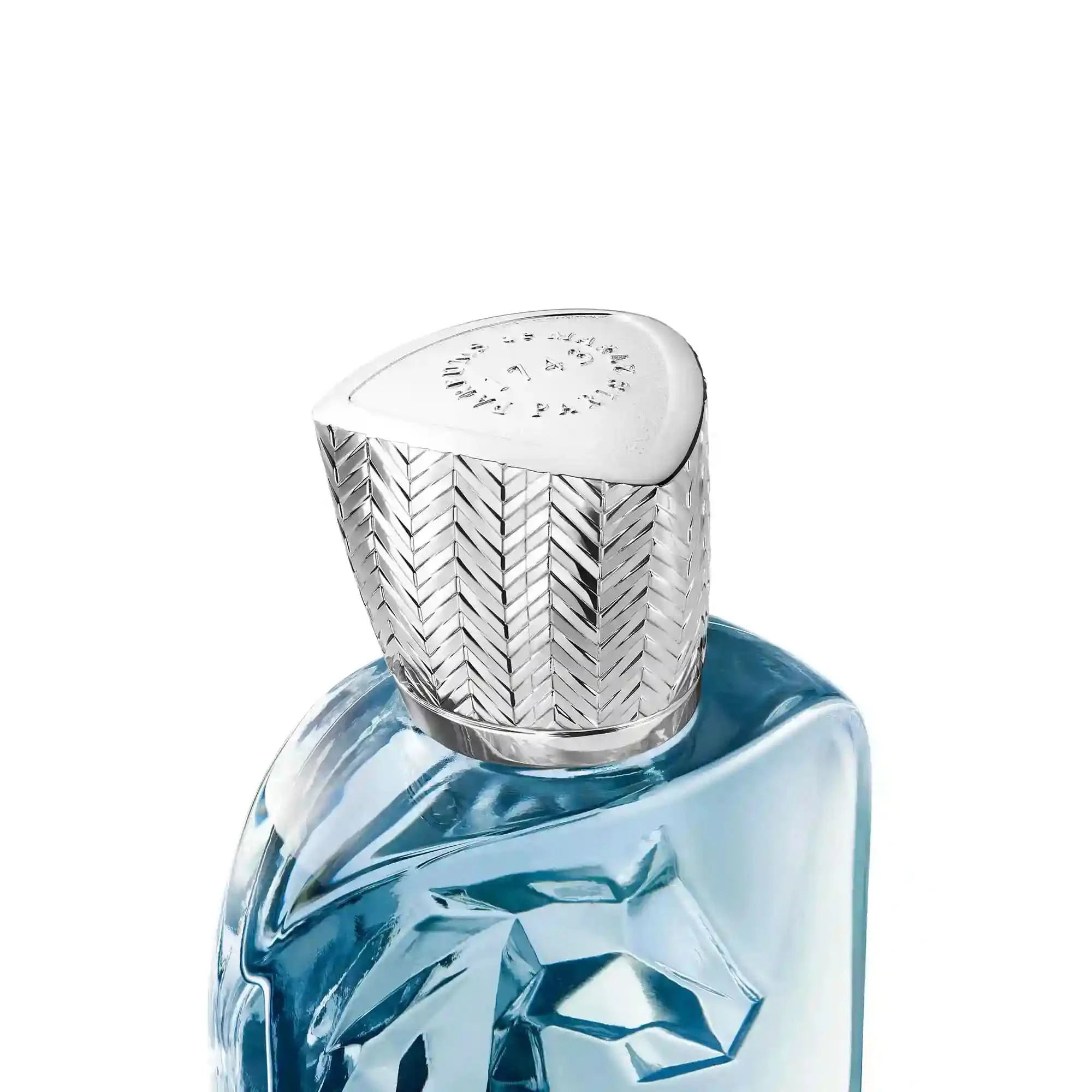 Blue perfume bottle with a silver cap on a white background