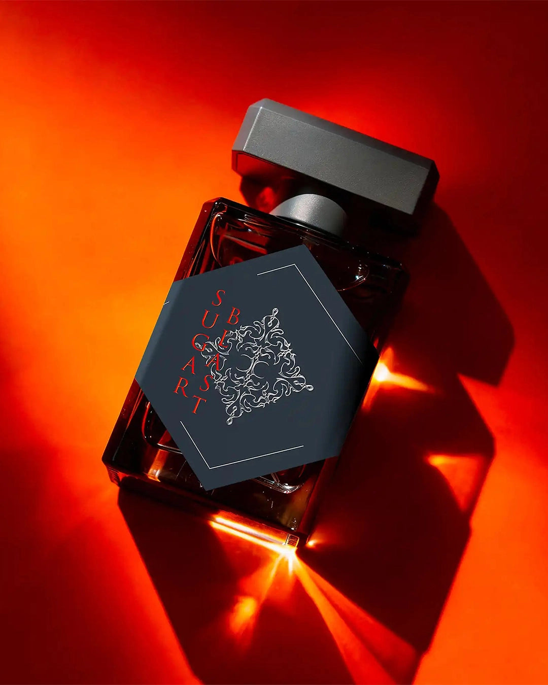Perfume bottle with intricate design on a red background