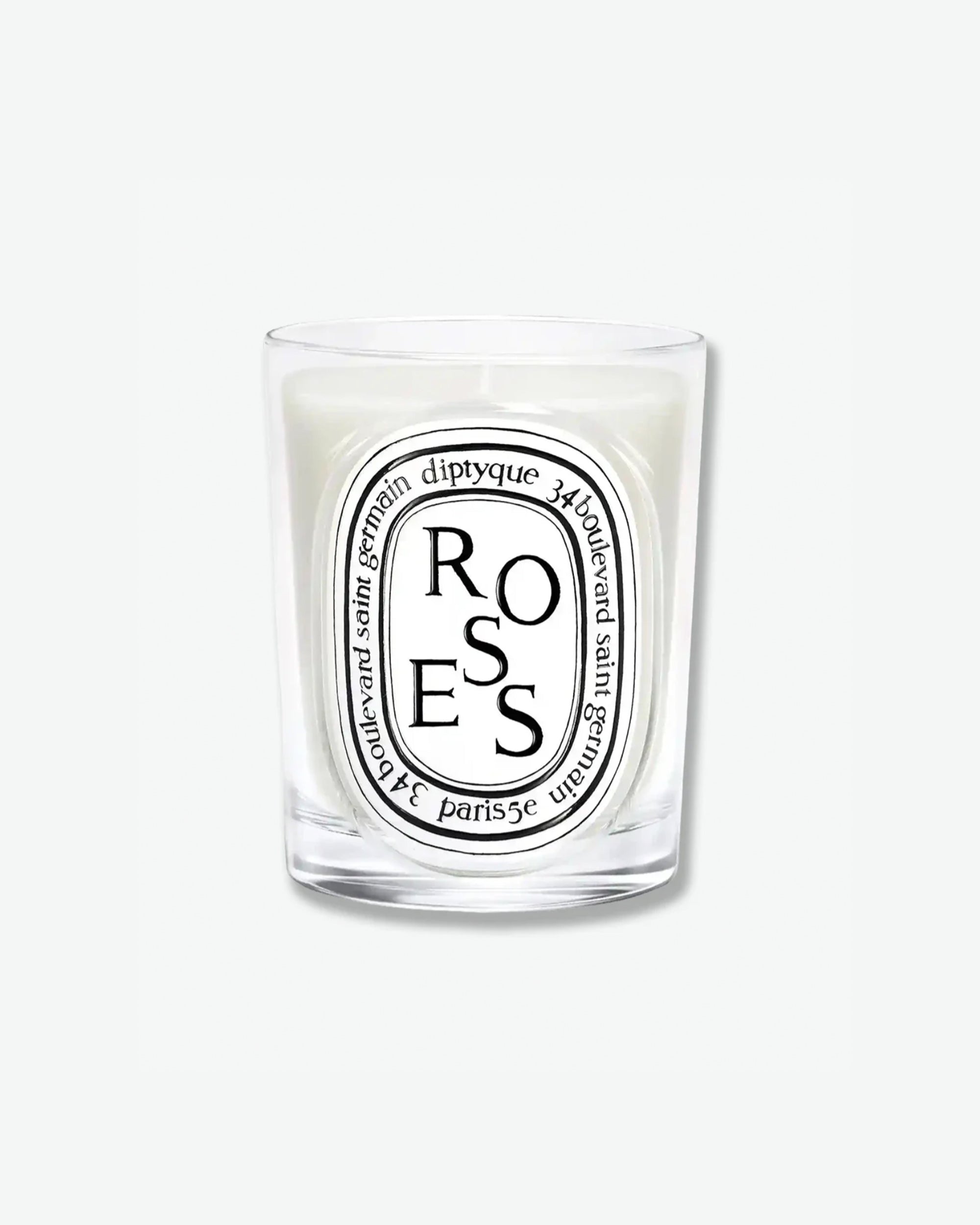 Diptyque Roses scented candle in a classic clear glass jar featuring the signature white oval logo with black lettering, isolated on a light grey background.