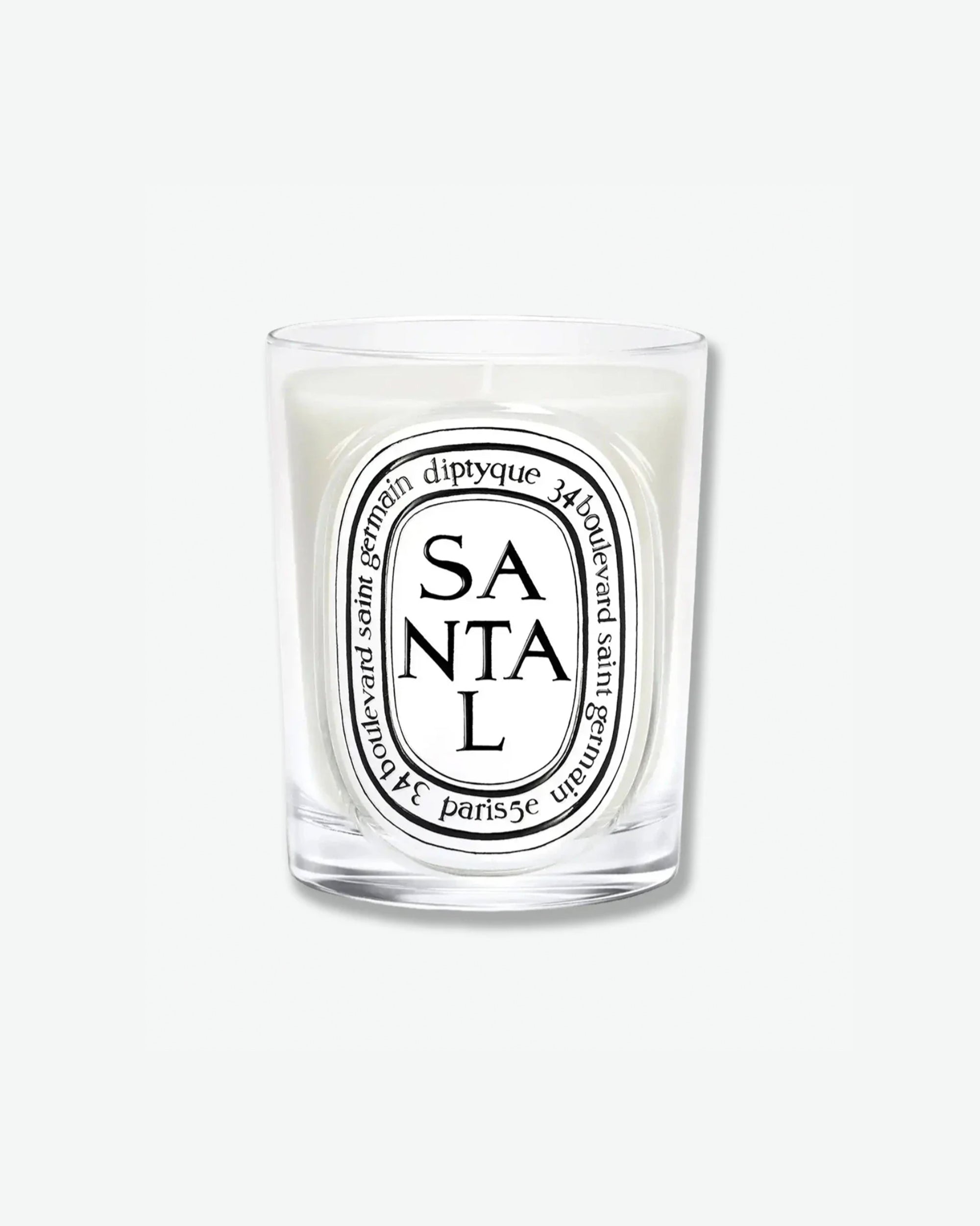 Diptyque Santal scented candle in a classic clear glass jar featuring the signature white oval logo with black lettering, isolated on a light grey background.