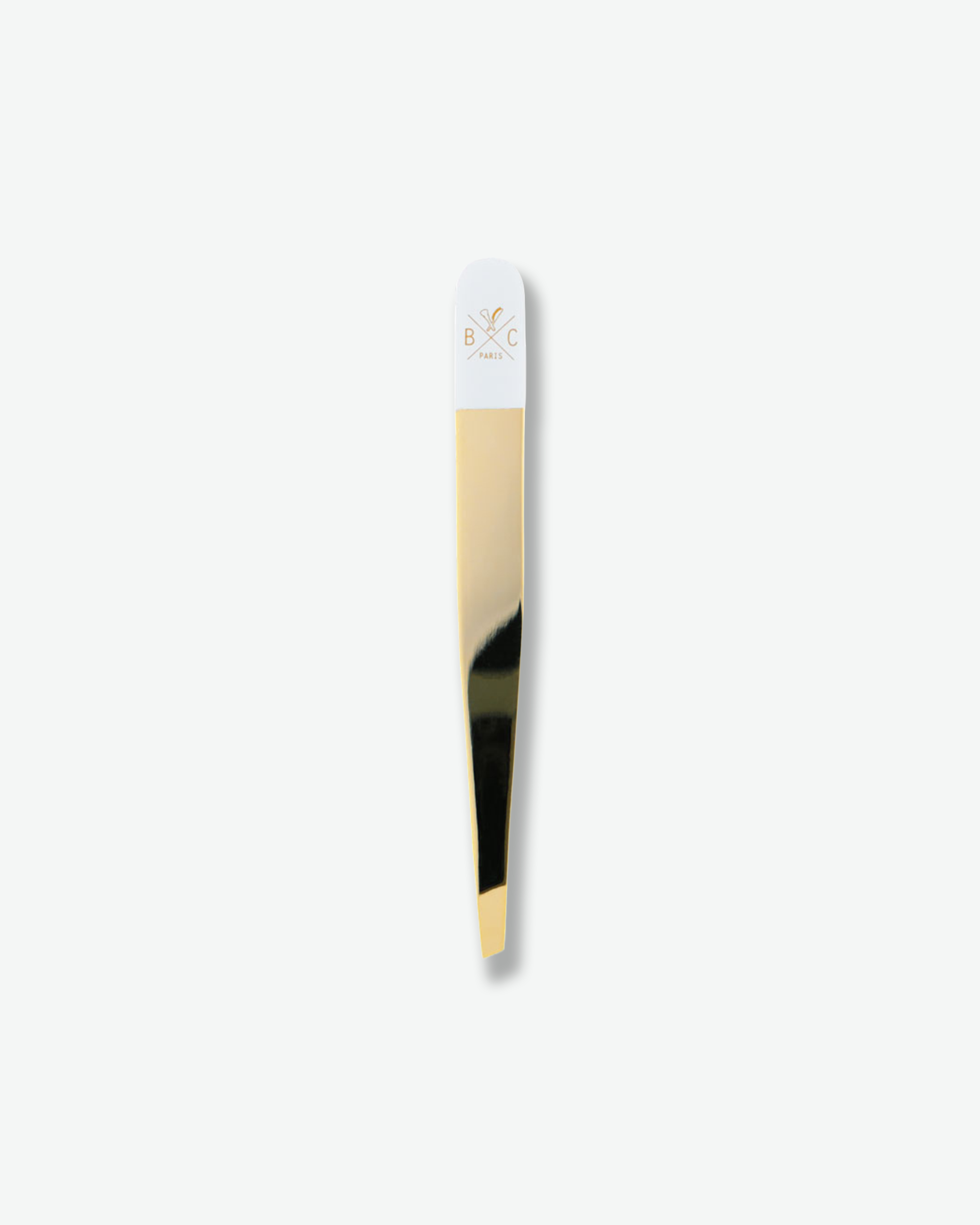 Luxury gold and white slanted tweezers isolated on a plain white background.