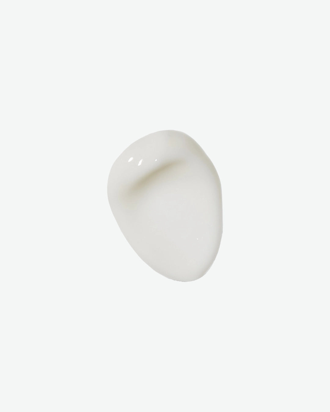 A top-down product texture shot showing a single smooth, creamy swatch of white eye cream isolated against a clean white background.