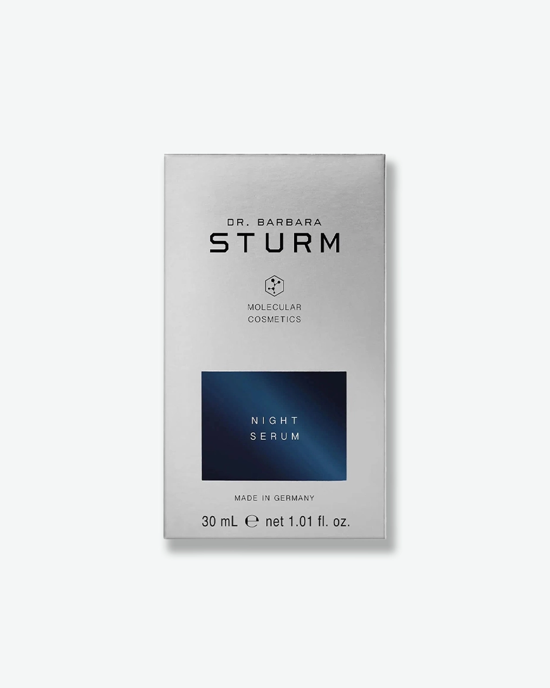 A product shot of the silver cardboard box for Dr. Barbara Sturm Night Serum, centered against a light gray background. It displays the standard black brand text with a dark navy blue rectangle contrasting against the silver, highlighting the words "NIGHT SERUM". The bottom text reads "30 mL e net 1.01 fl. oz."