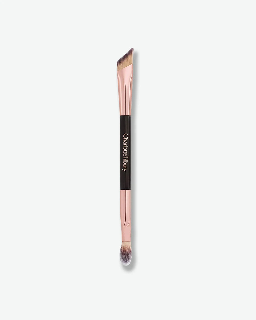 Dual-ended makeup brush with rose gold ferrule and black handle on a white background