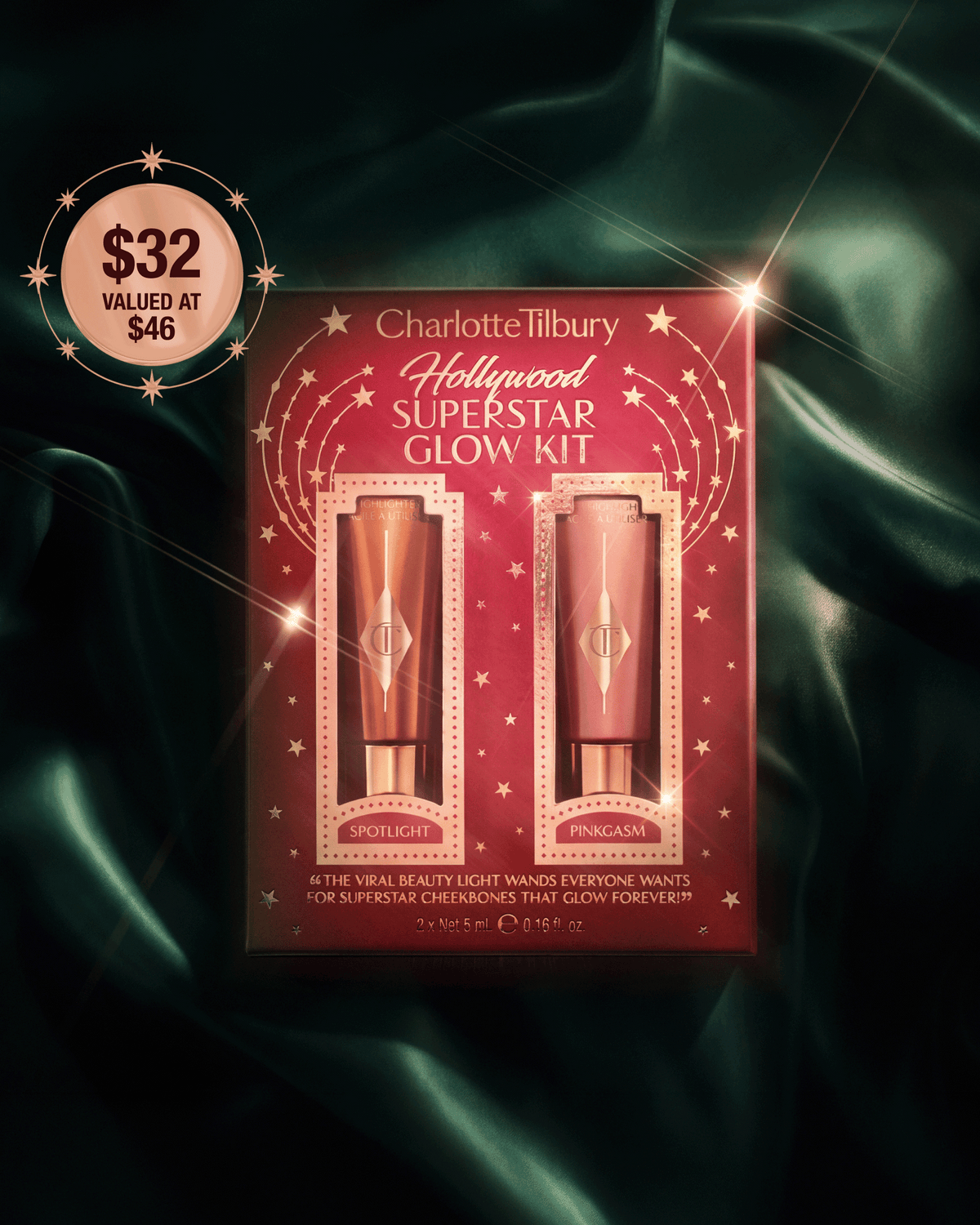 Charlotte Tilbury Hollywood Superstar Glow Kit featuring Spotlight and Pinkgasm Beauty Light Wands on dark green satin.