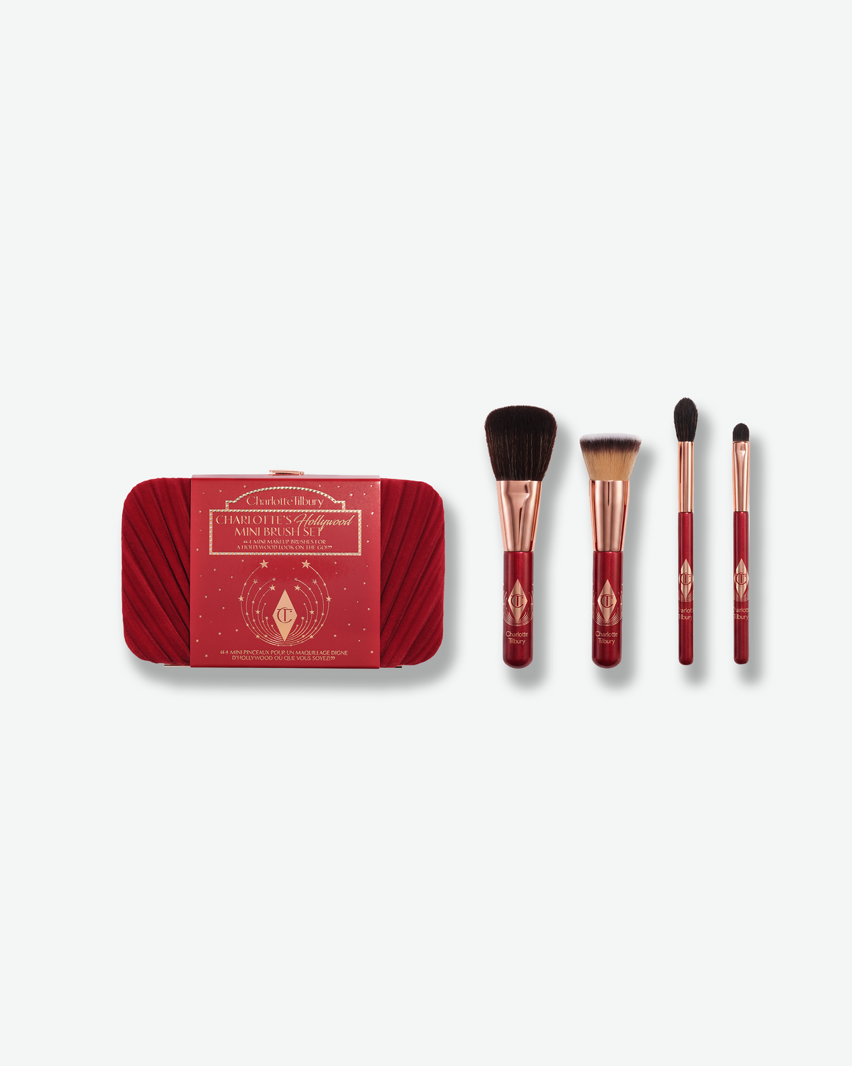 Charlotte Tilbury Hollywood Mini Brush Set with red velvet clutch and four mini makeup brushes.