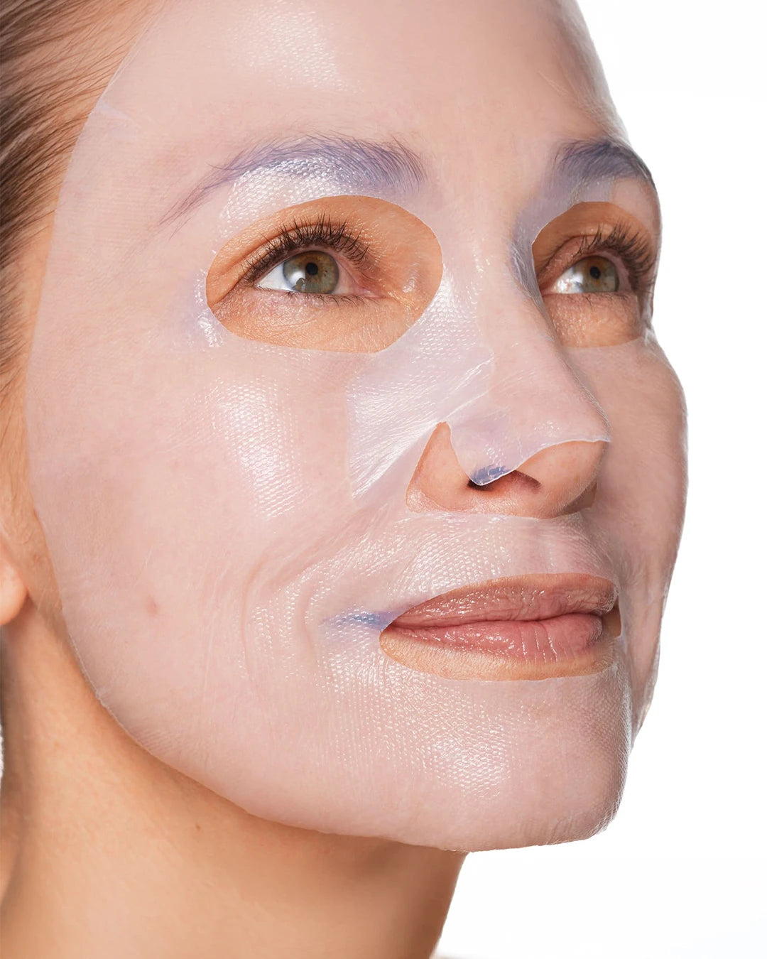 Close-up of a person wearing a face mask with a neutral background