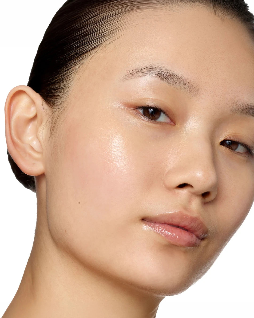 Close-up of a person's face with a neutral expression on a white background