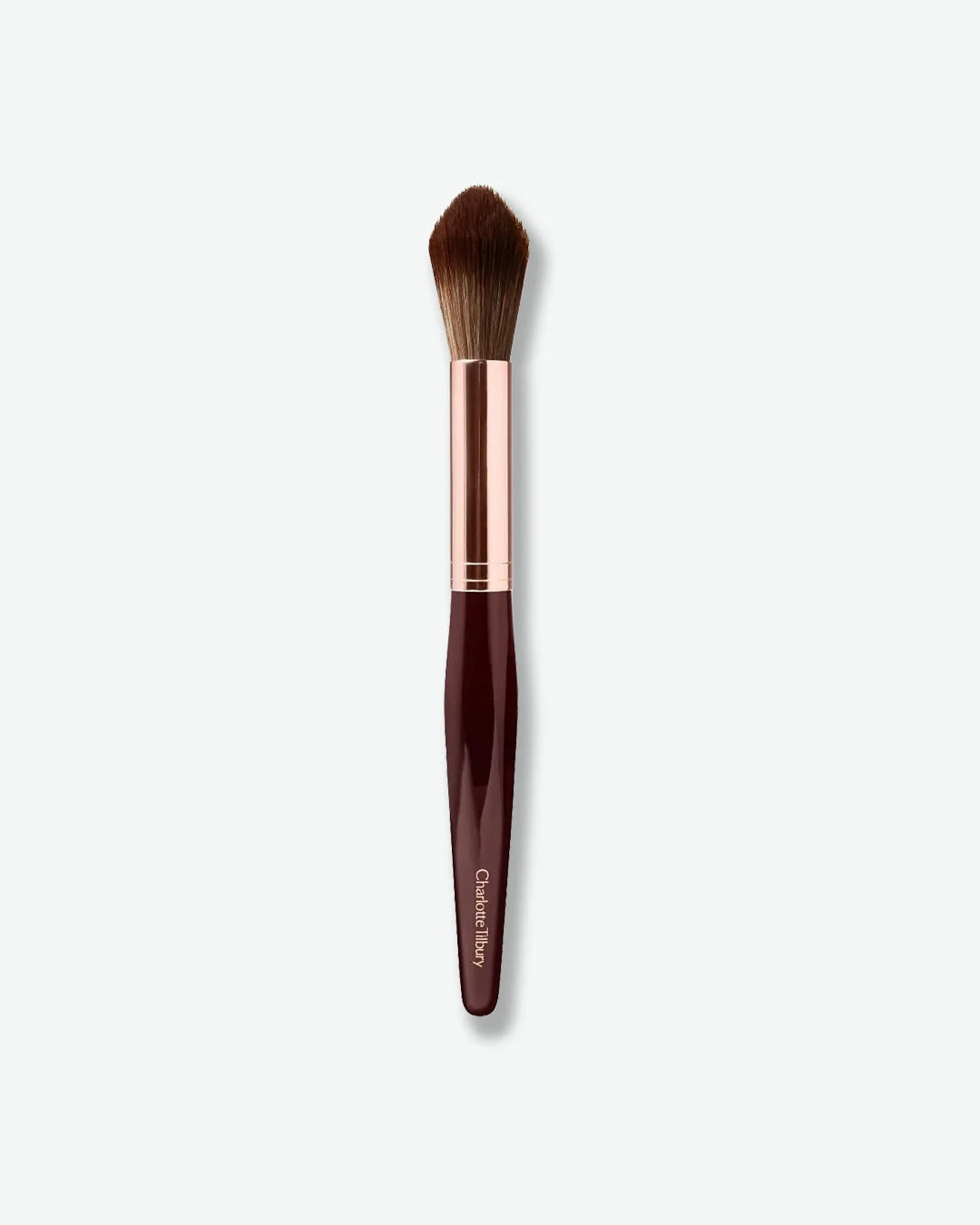 Makeup brush with a rose gold ferrule and brown handle on a white background