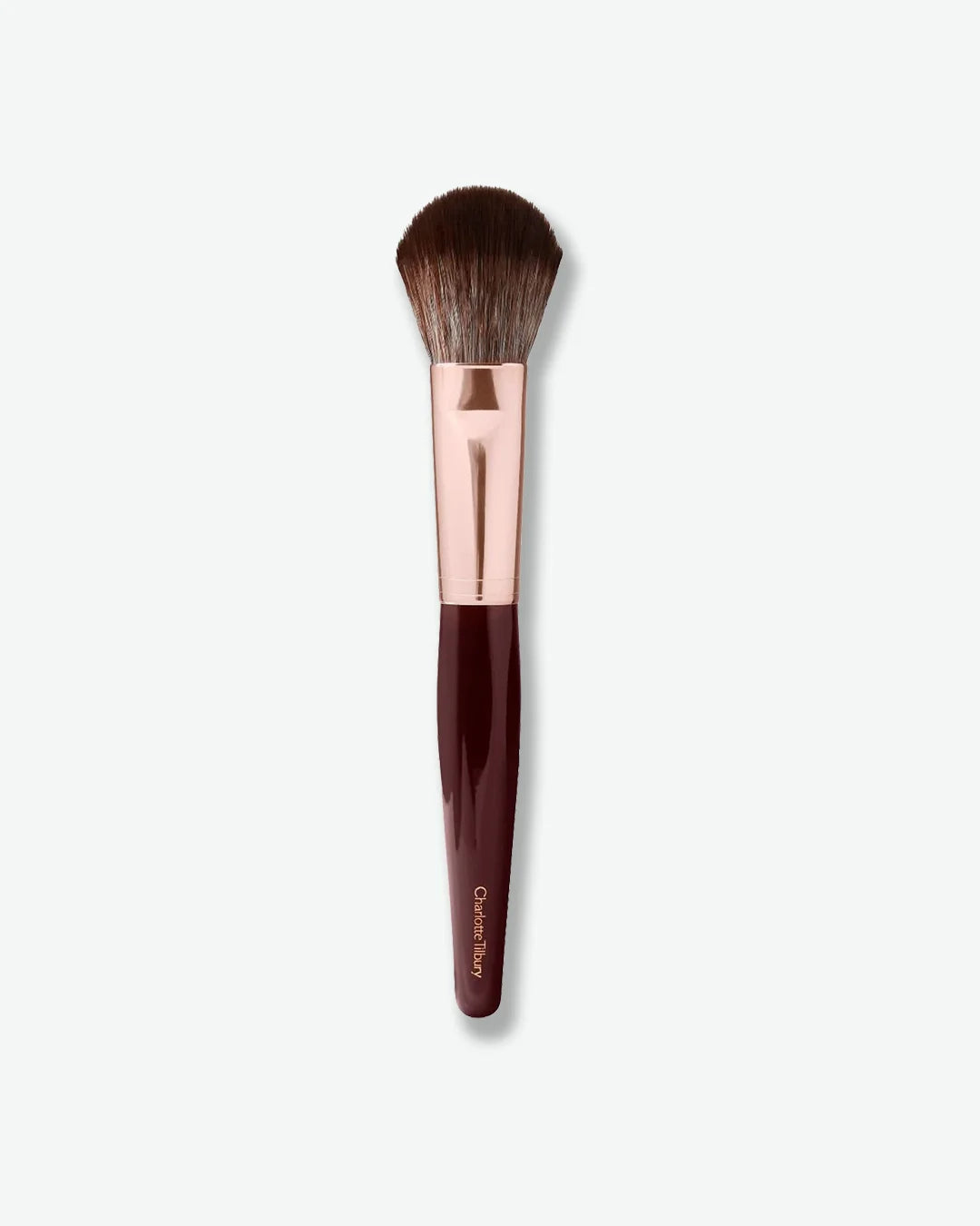 Makeup brush with rose gold ferrule and brown handle on a white background