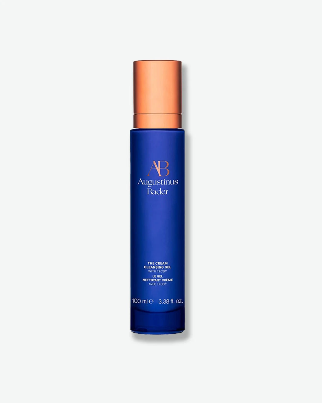 Blue Augustinus Bader The Cream Cleansing Gel bottle with a copper cap, centered against a light grey background.