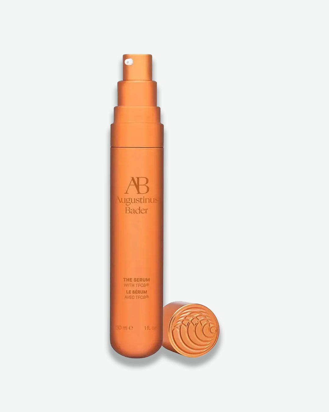 Orange serum bottle with cap on a white background