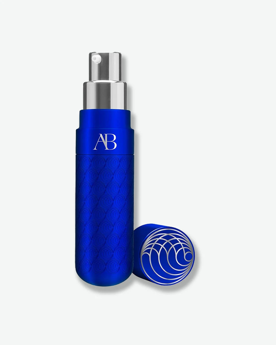 Blue Augustinus Badar bottle with silver pump nozzle and blue cap off centered against a light grey background