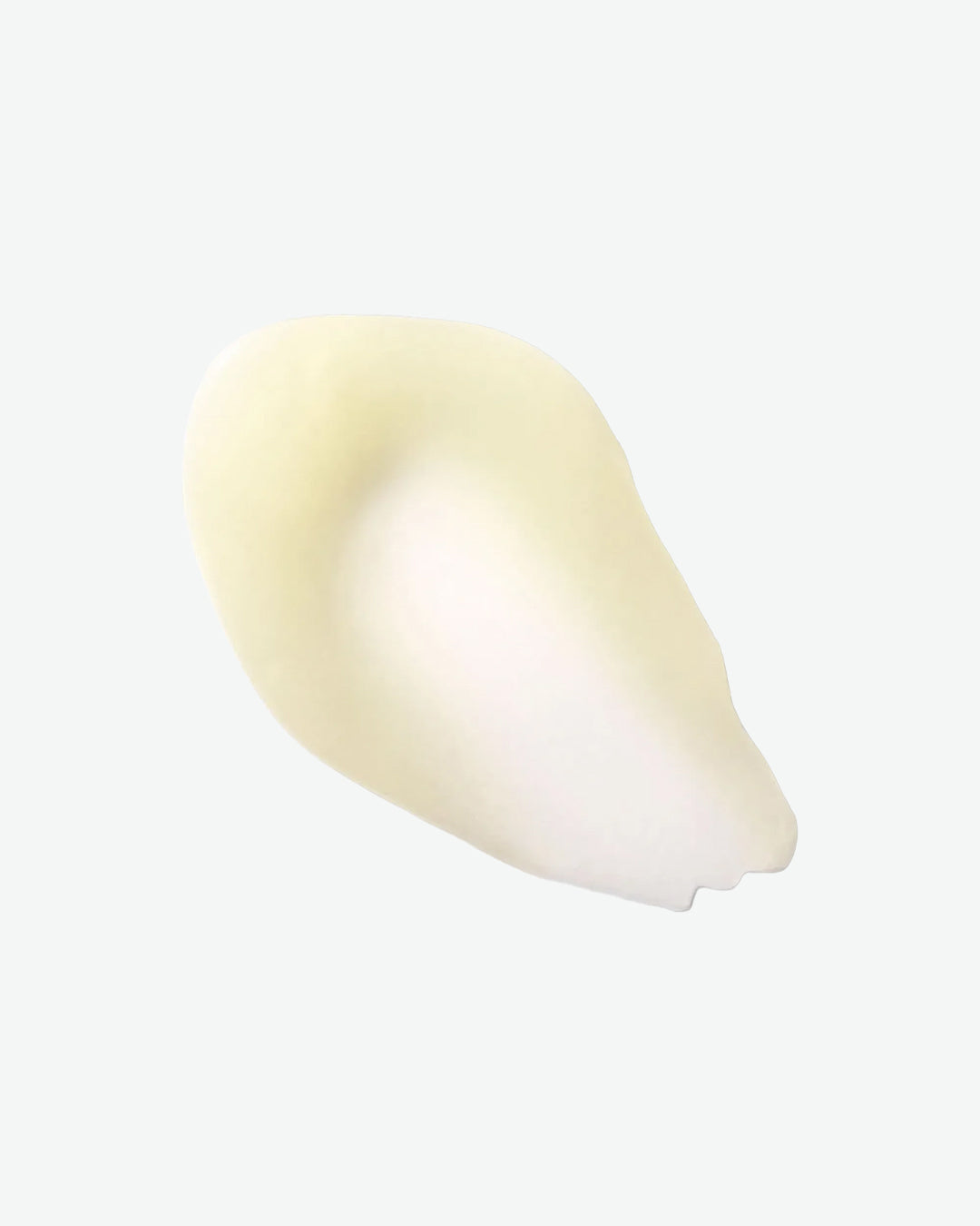 White cosmetic product on a light gray background