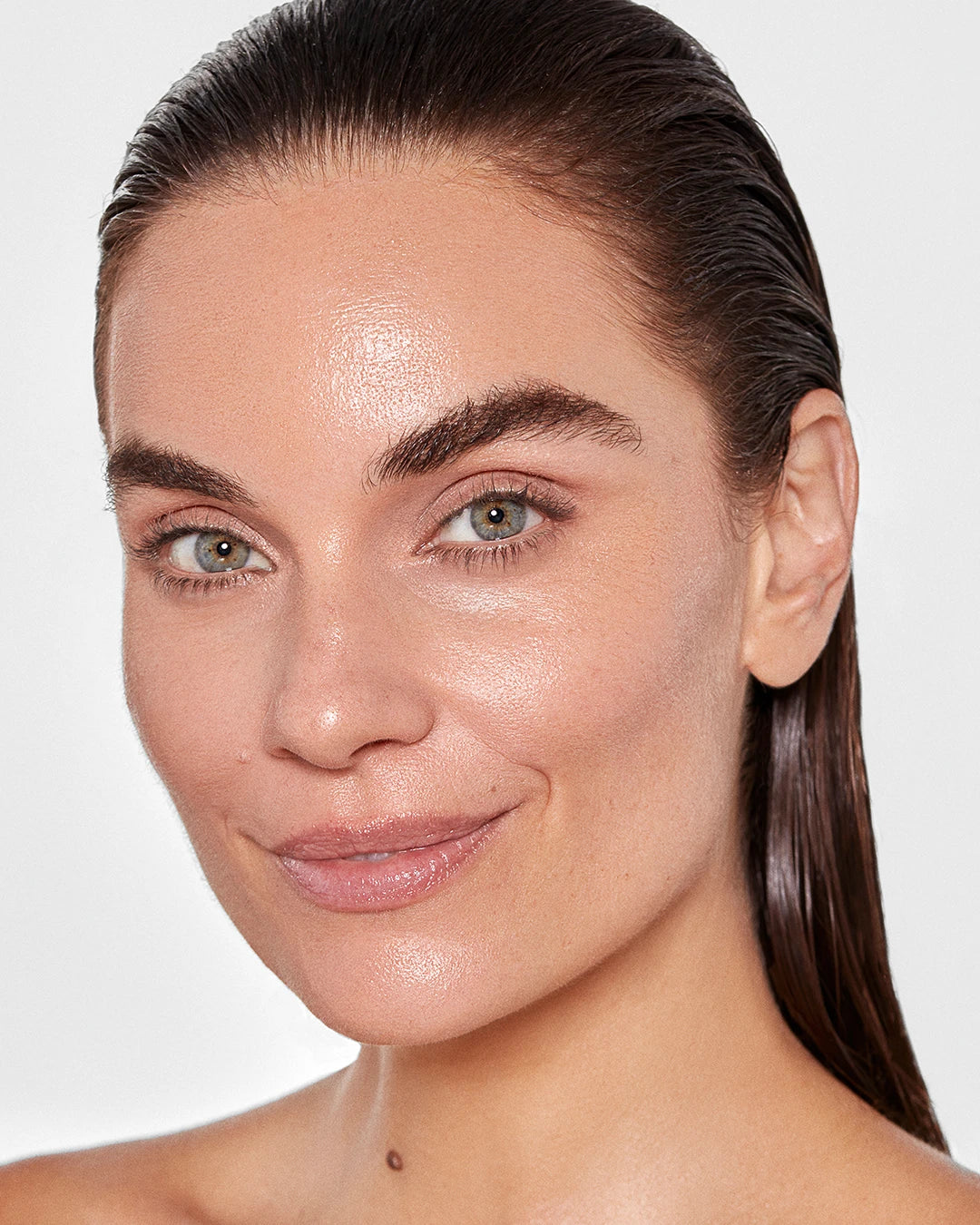 Close-up of a woman's face with a neutral background