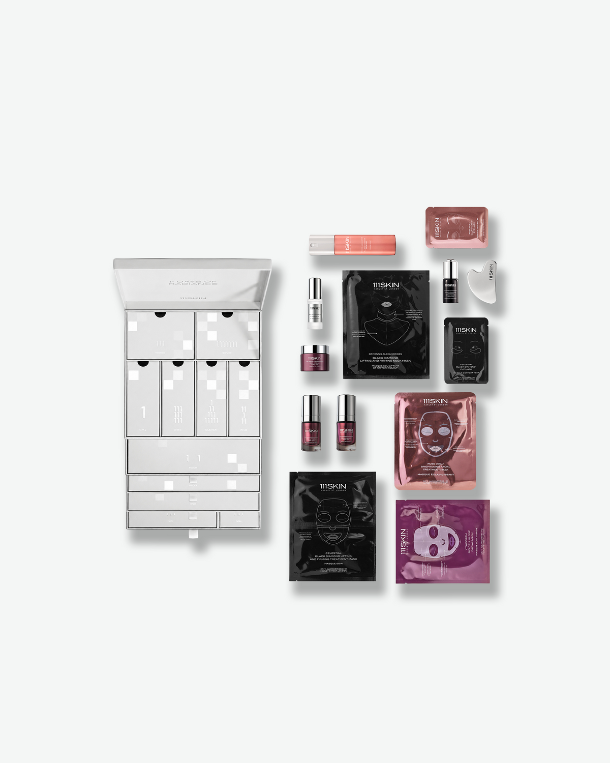 111SKIN 11 Days of Radiance advent-style skincare set shown open with a curated assortment of masks, serums, eye treatments, and skincare essentials.