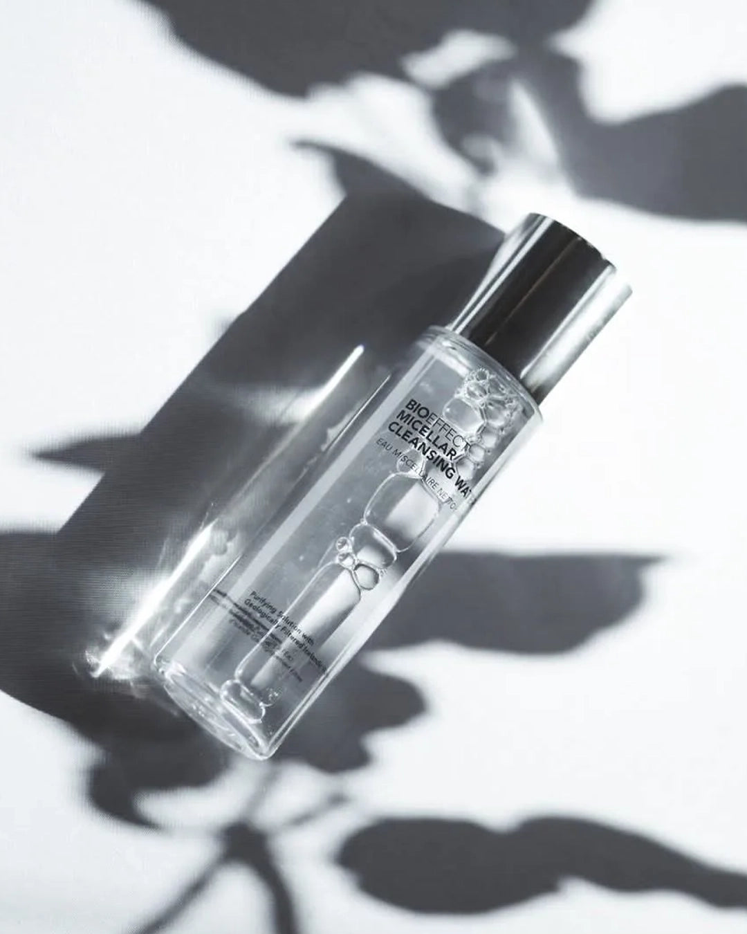 Clear skincare bottle with dropper on a white background