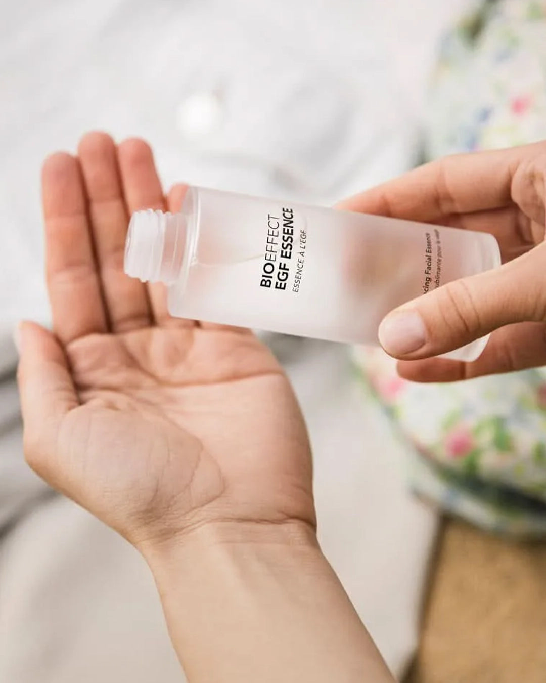 Person holding a bottle of Bioeffect EGF Essence in a bathroom setting