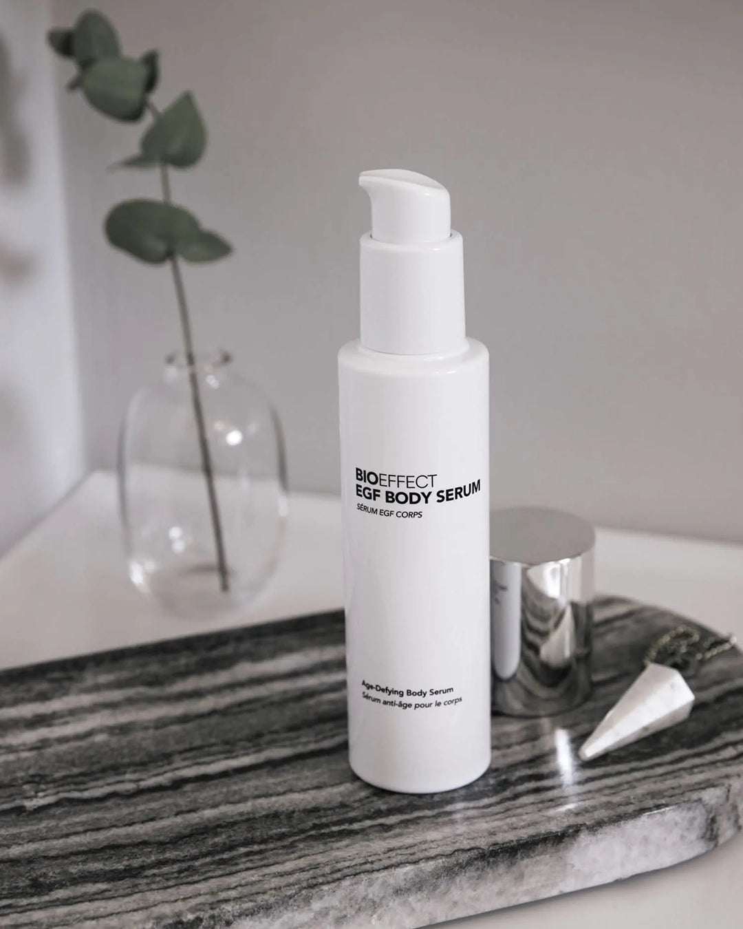 Bioeffect EGF Body Serum bottle on a marble surface with a blurred background