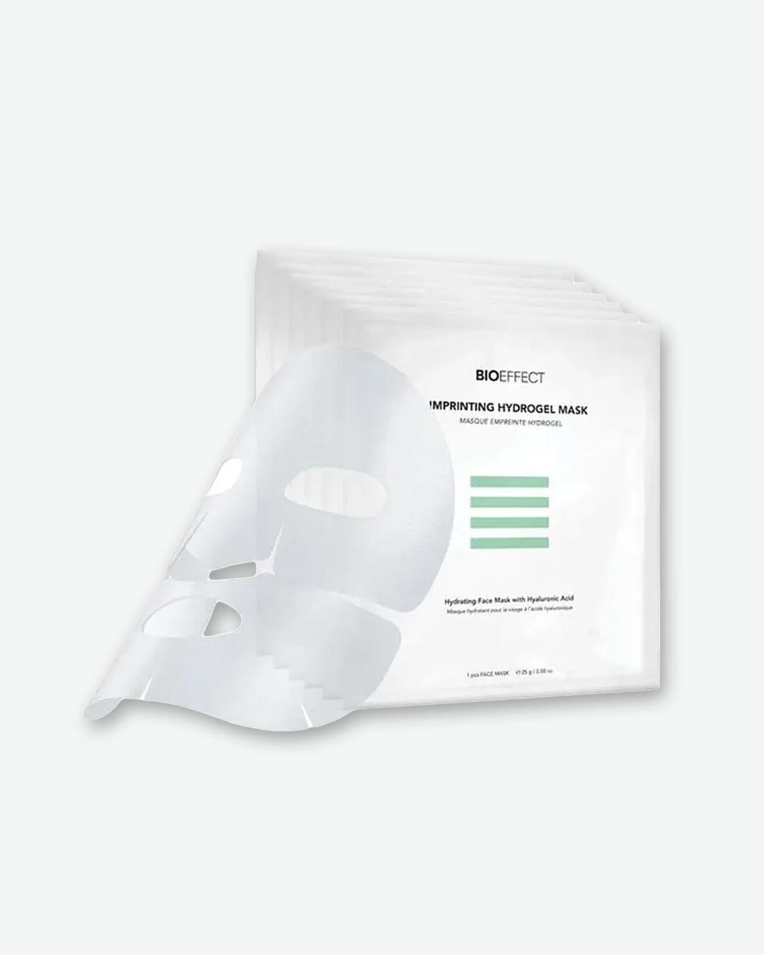 An unfolded translucent BIOEFFECT Imprinting Hydrogel Mask draped over a stacked fan of multiple white single-use mask sachets.